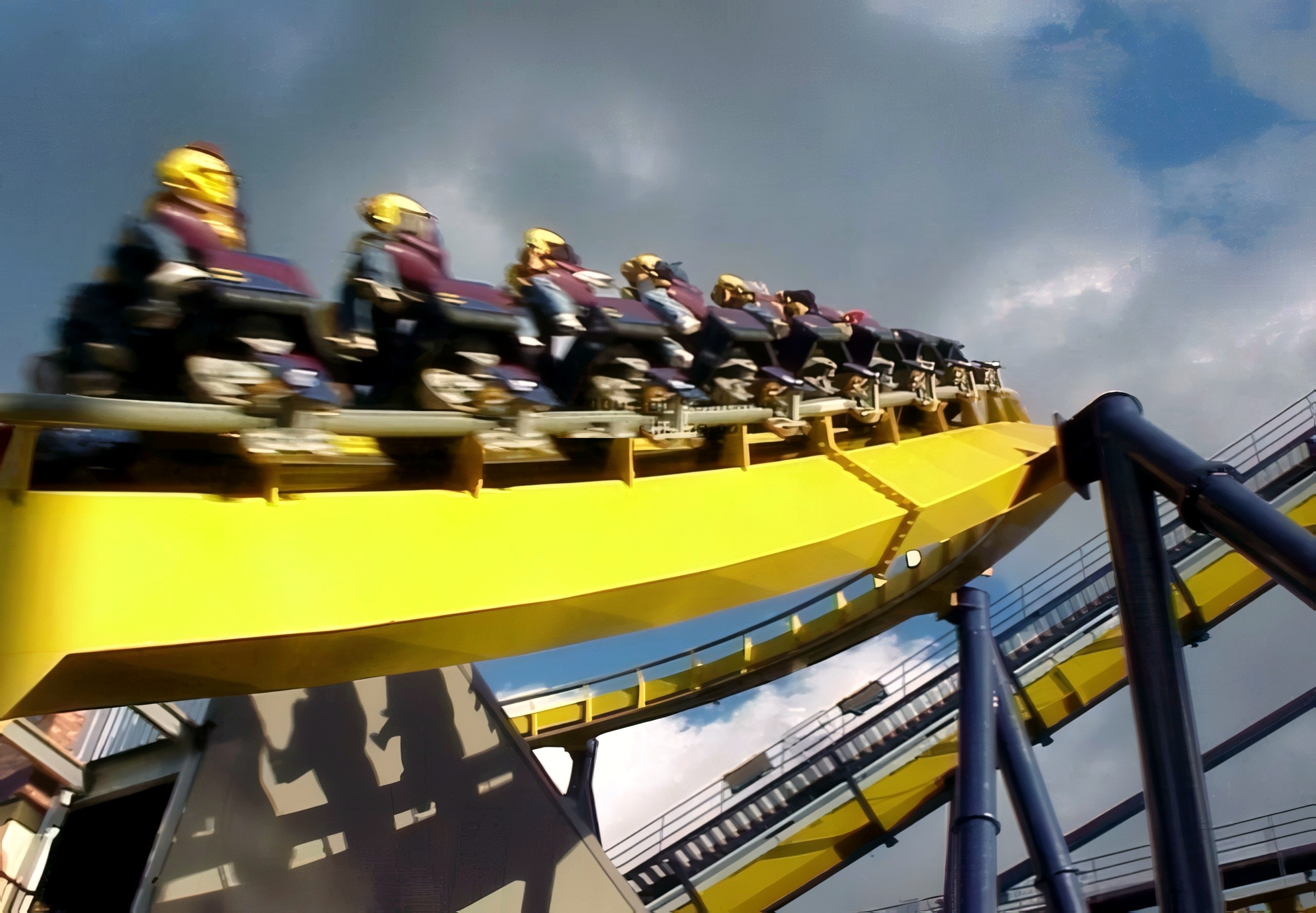 Riders zooming by on Batman Knight Flight's yellow track at Geauga Lake, May 2000