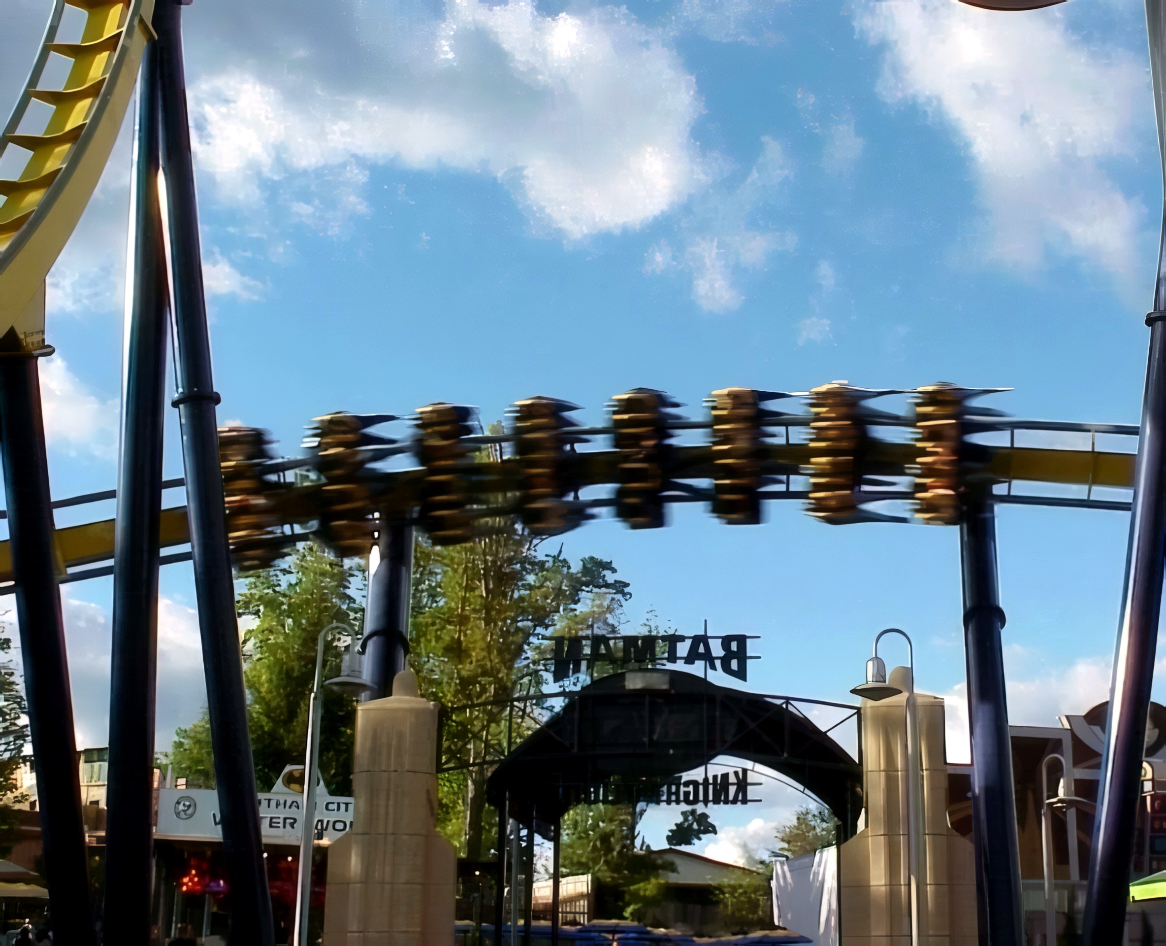 A Batman Knight Flight train passing over the entrance sign at Geauga Lake, May 2000