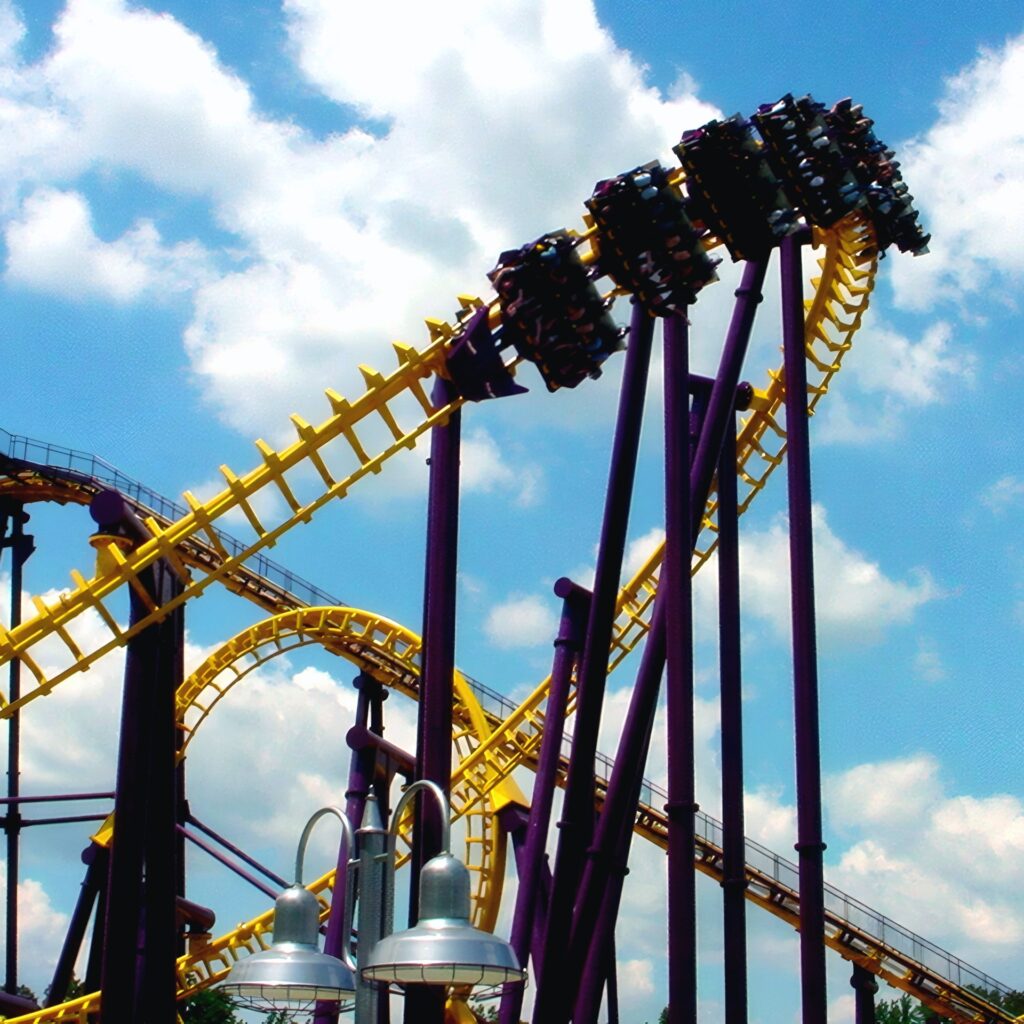 Batwing at Six Flags America: a train flying through the inversion above the yellow track