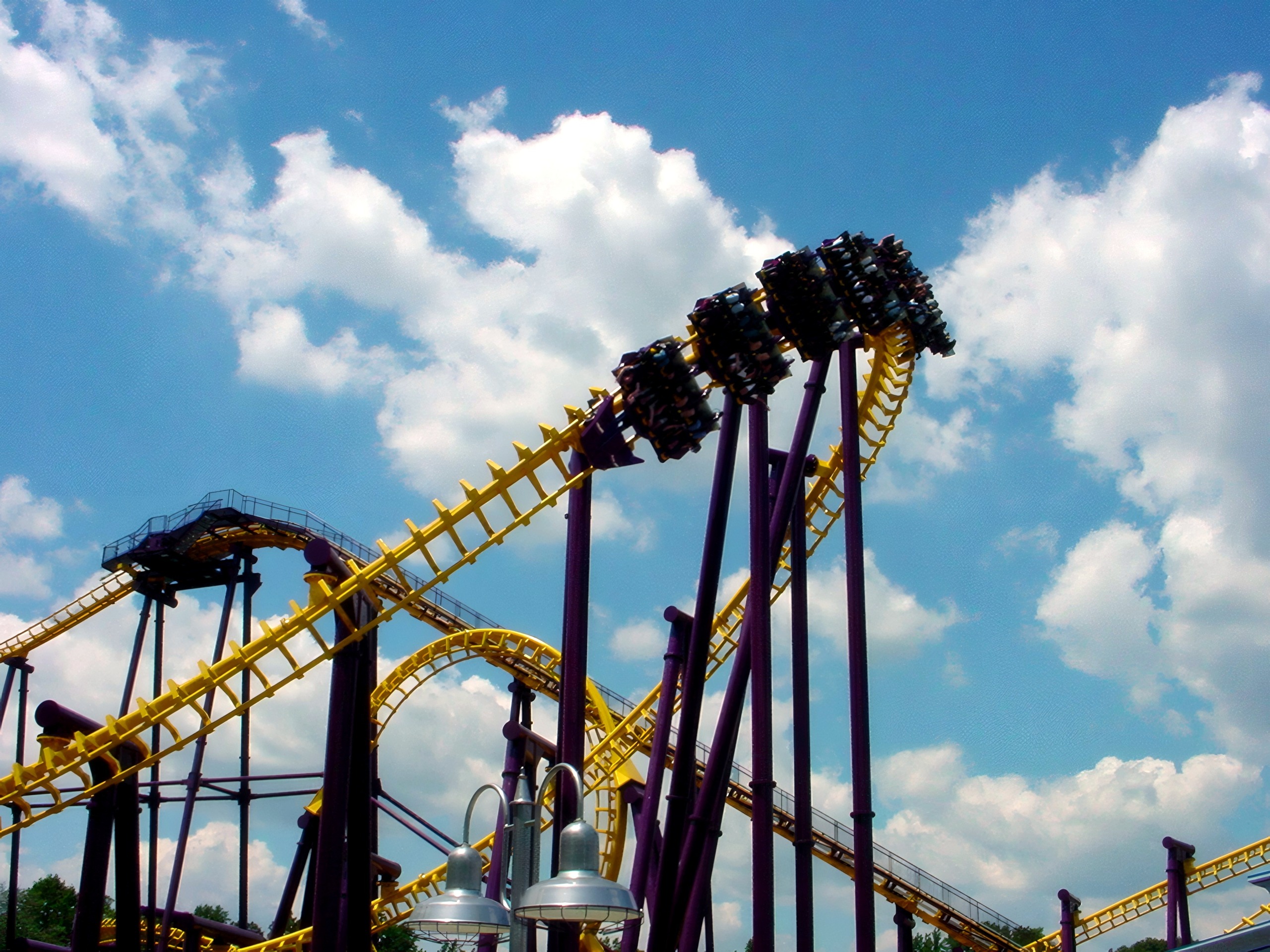A Batwing train flying through the inversion above the yellow track at Six Flags America, July 2001