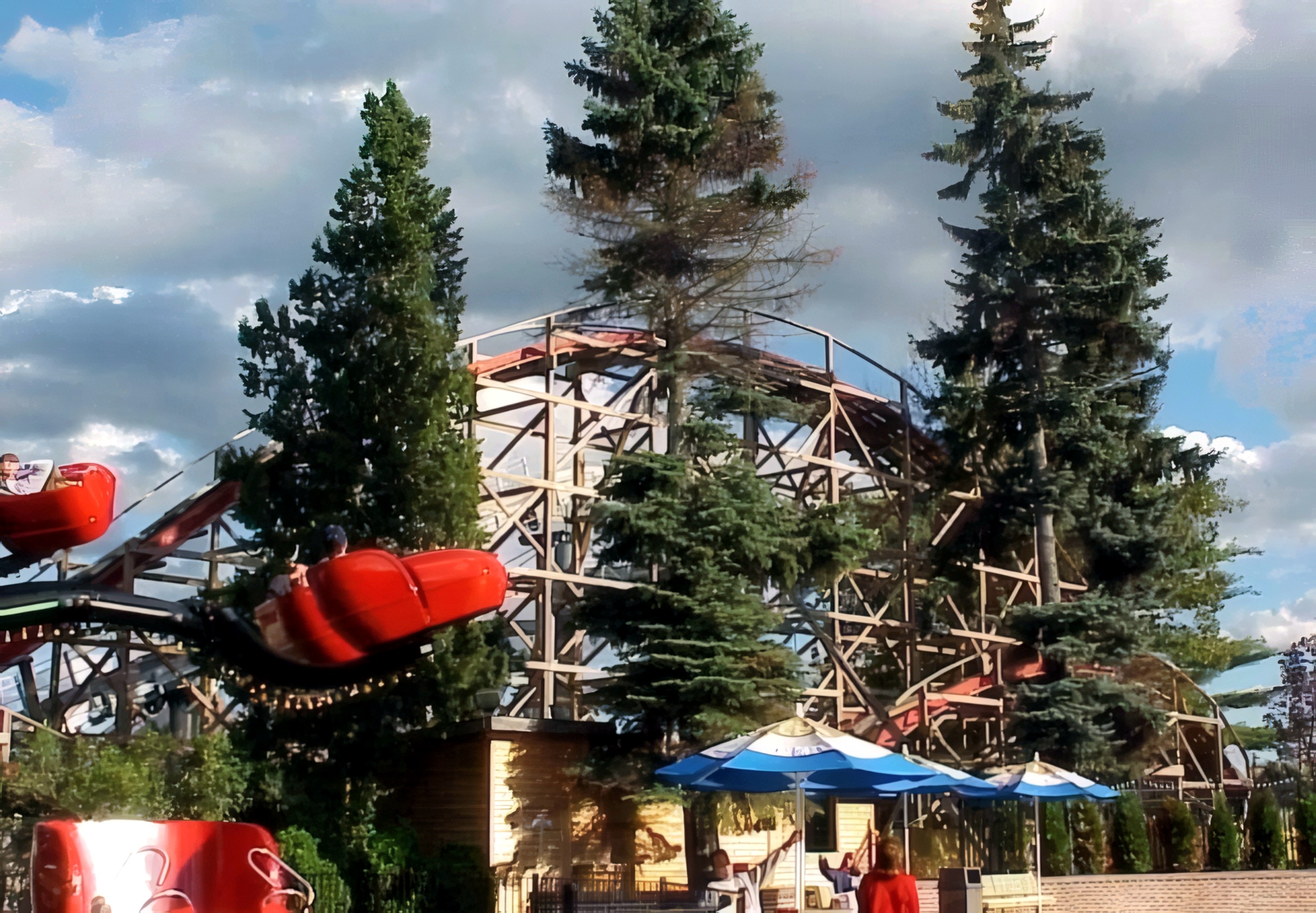 Big Dipper's train banking through a turn beside the evergreens at Geauga Lake, May 2000