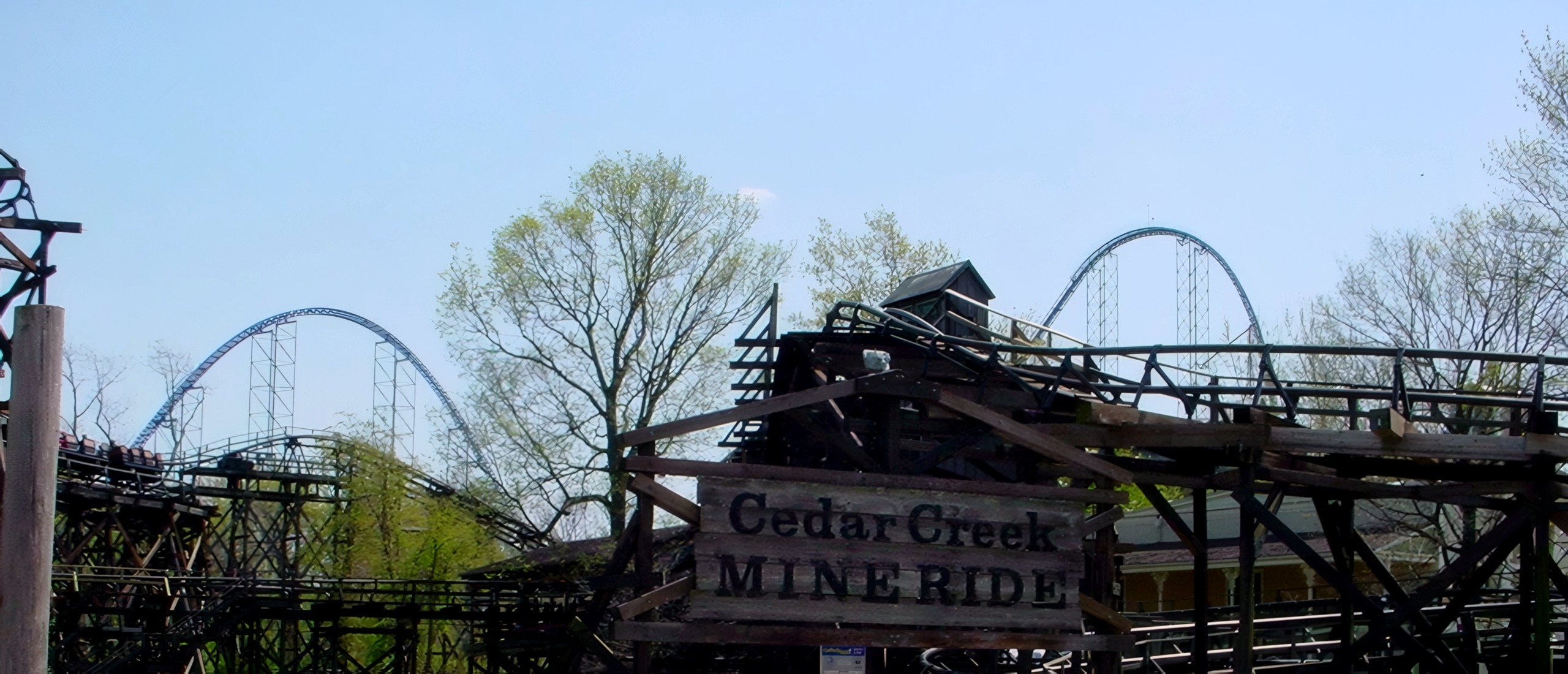 The Cedar Creek Mine Ride entrance and sign with Millennium Force rising behind at Cedar Point, May 2002
