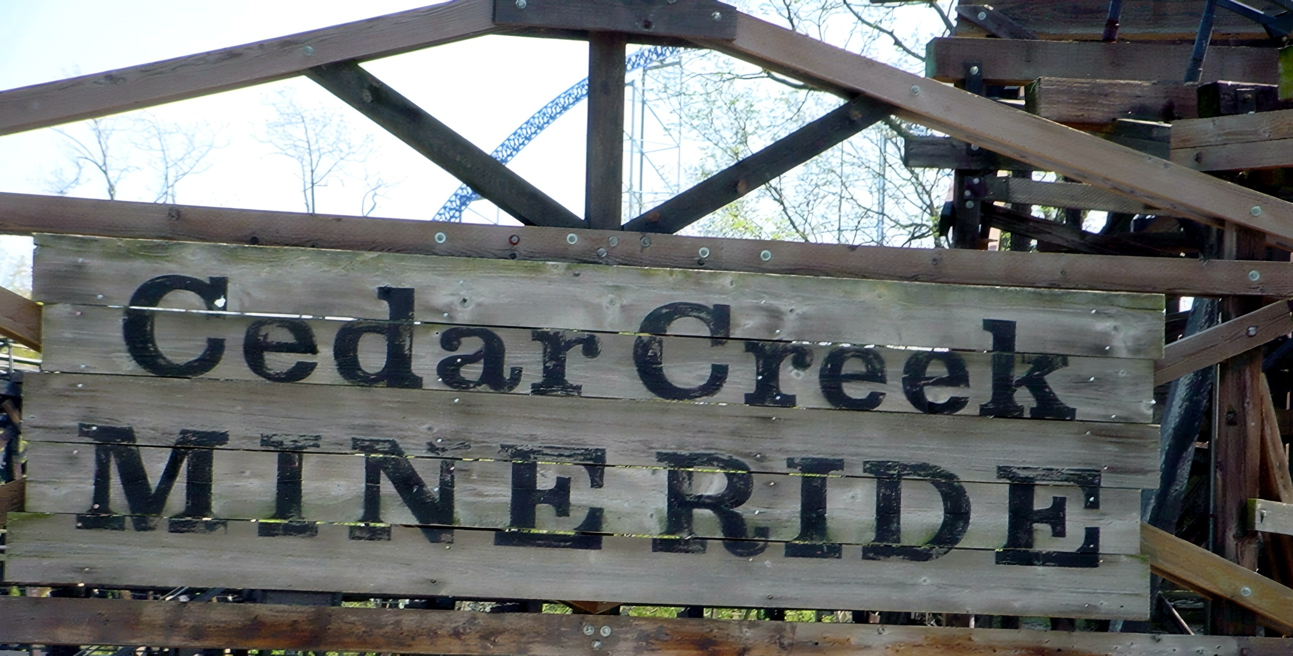 The weathered wooden Cedar Creek Mine Ride entrance sign at Cedar Point, May 2002