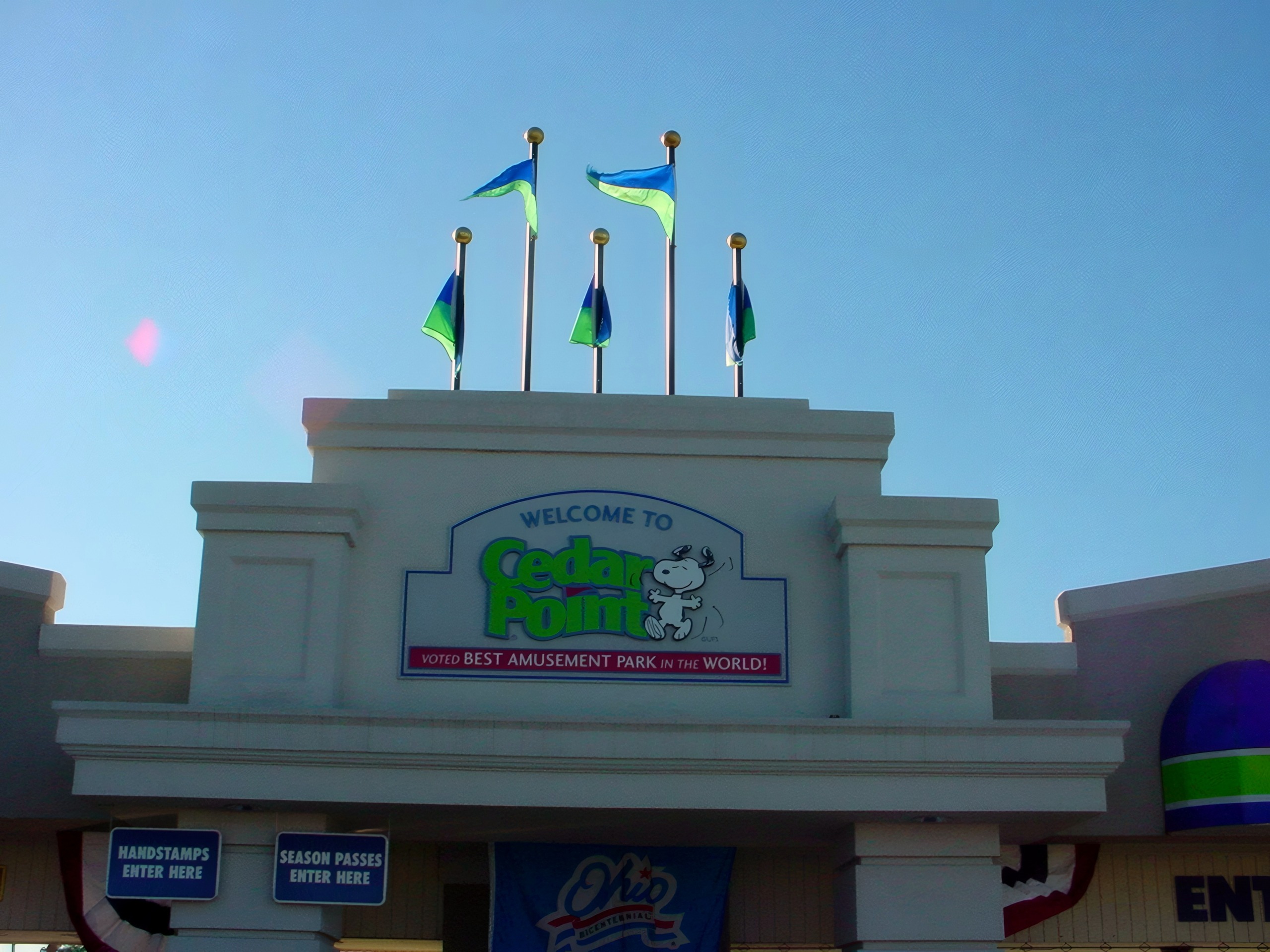The Welcome to Cedar Point main entrance sign with flags at Cedar Point, July 2003