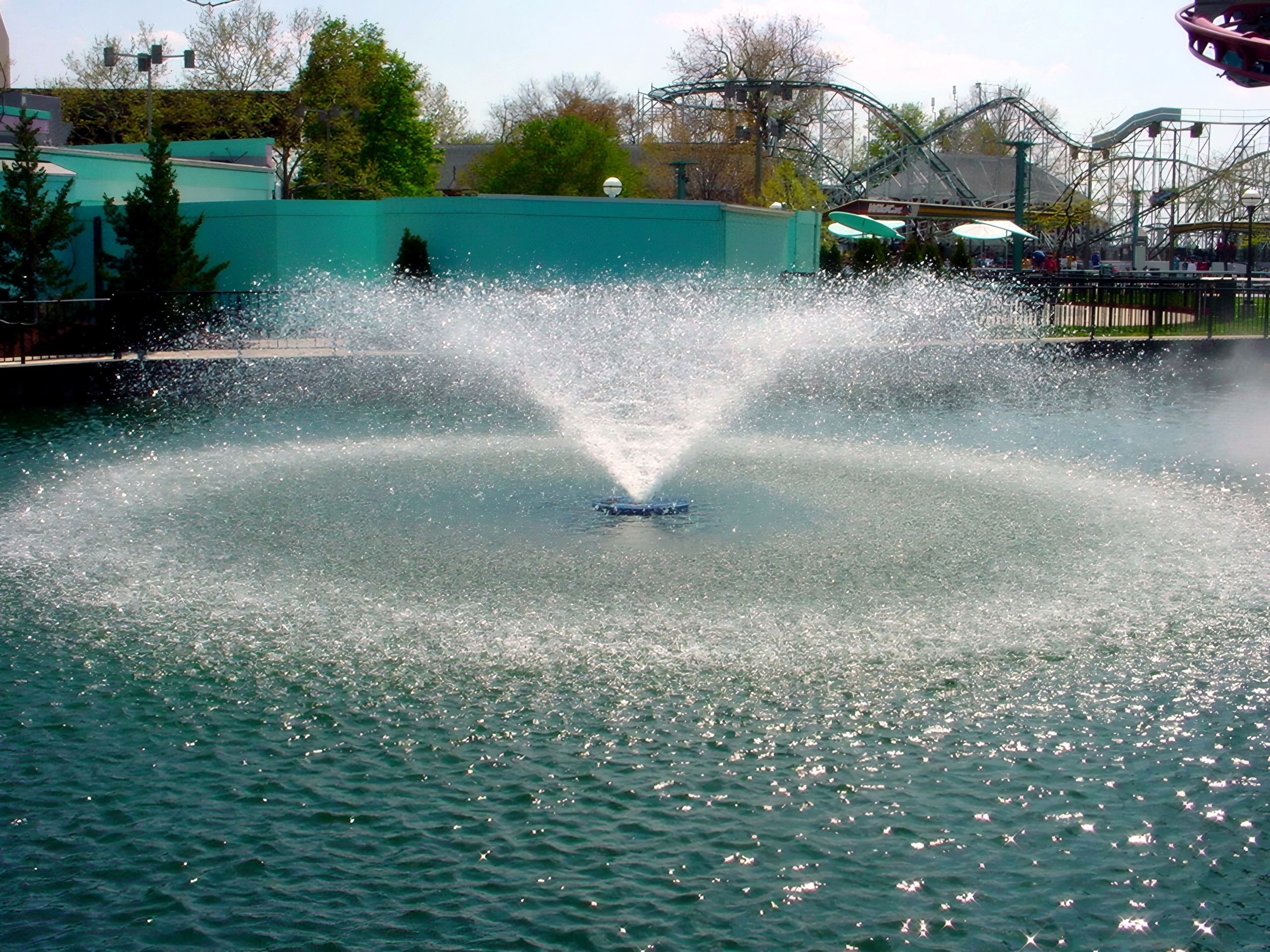 A lagoon fountain with coaster track behind at Cedar Point, May 2002