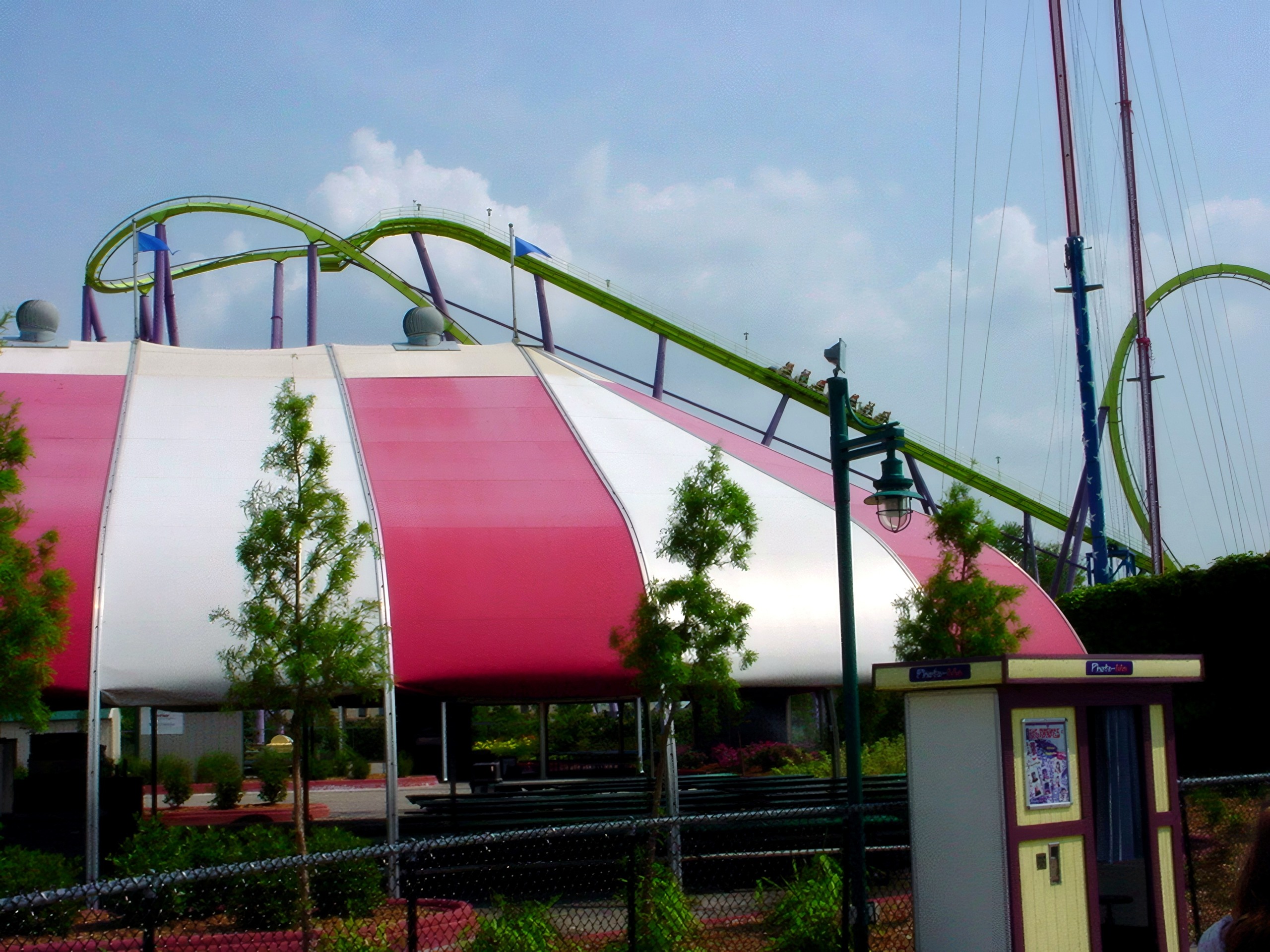 Green coaster loops behind red and white striped tent, Chang, July 2002