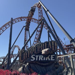 A Copperhead Strike train climbing the vertical loop above the snake sign, Carowinds, October 2024