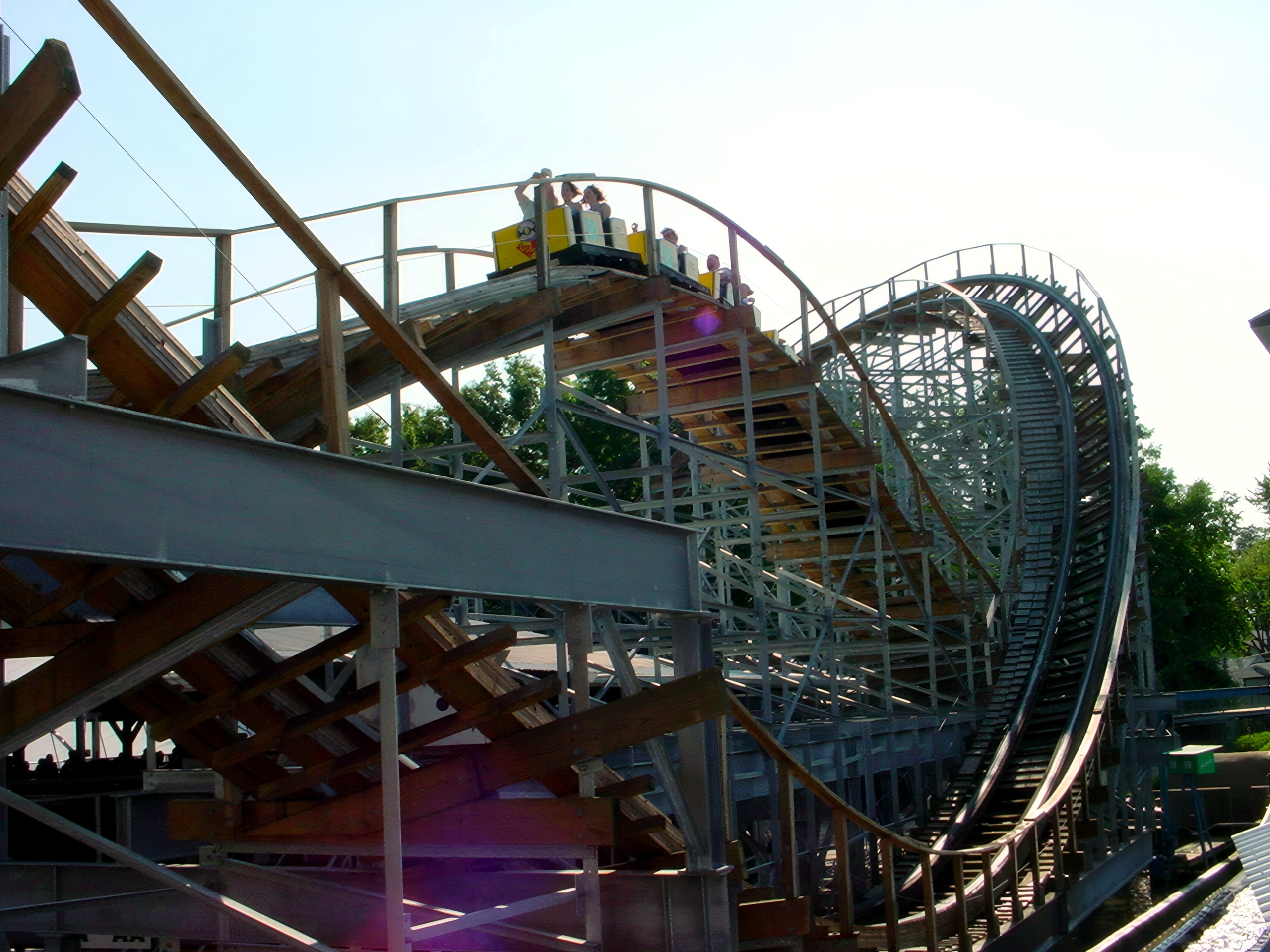 A Cornball Express train cresting a hill on the wooden structure, June 2002