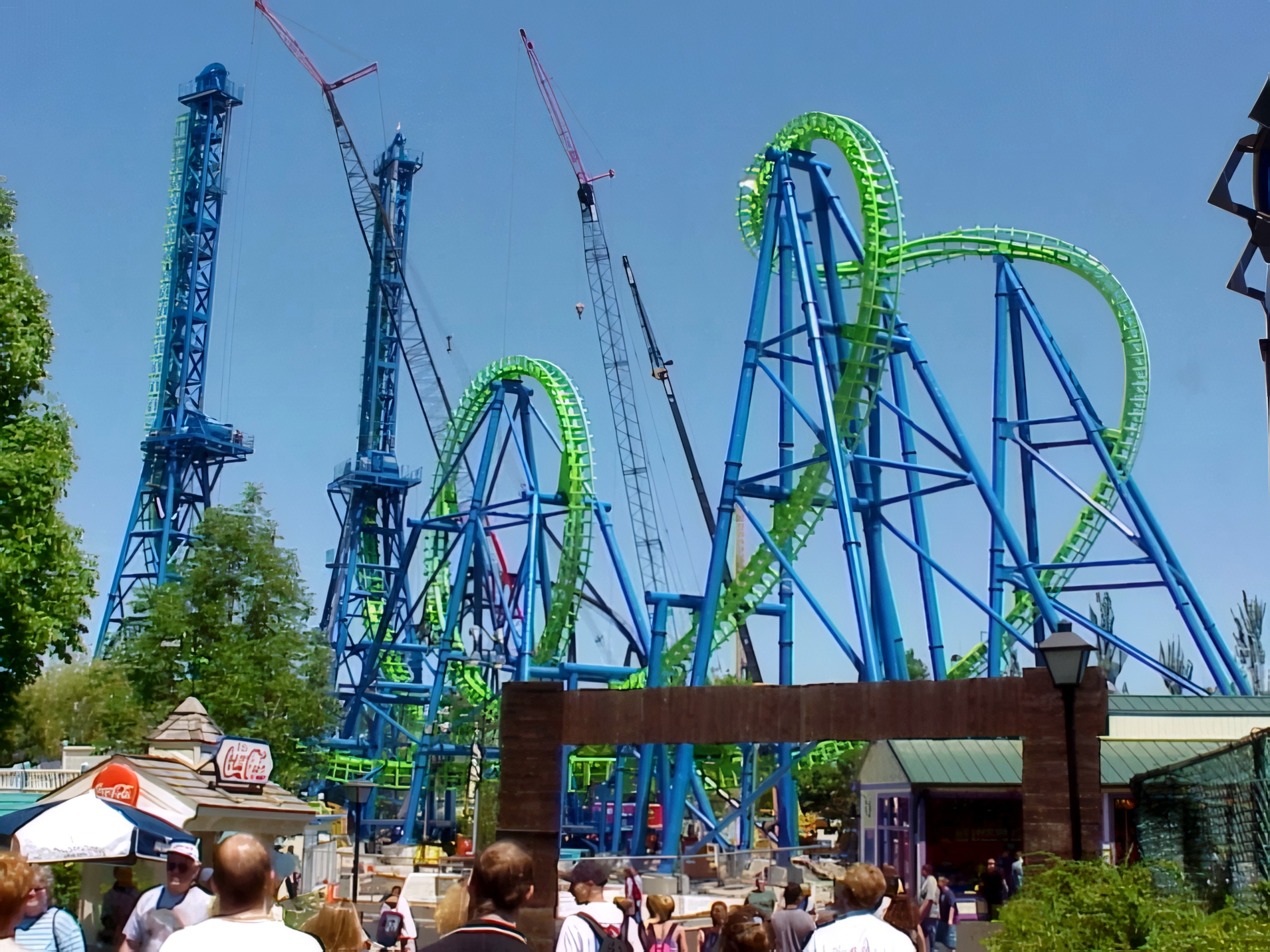 Déjà Vu's towers and cobra roll under construction above the crowd at Six Flags Great America, May 2001