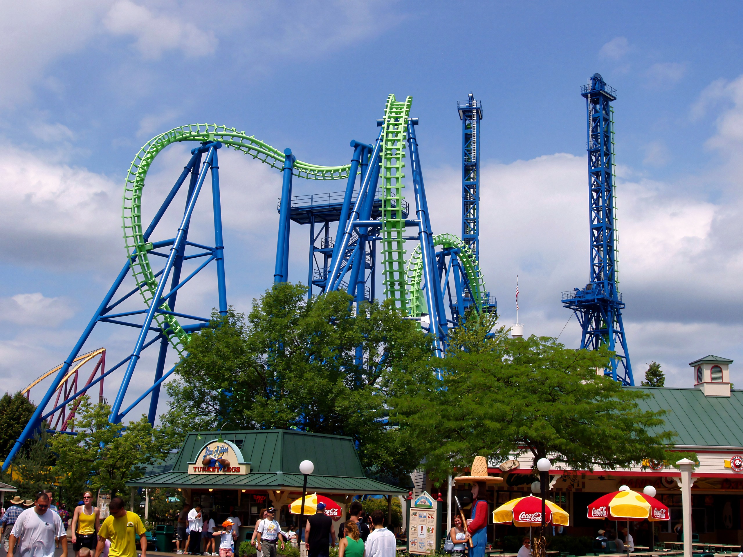 Déjà Vu's towers and cobra roll rising over the midway shops at Six Flags Great America, August 2005