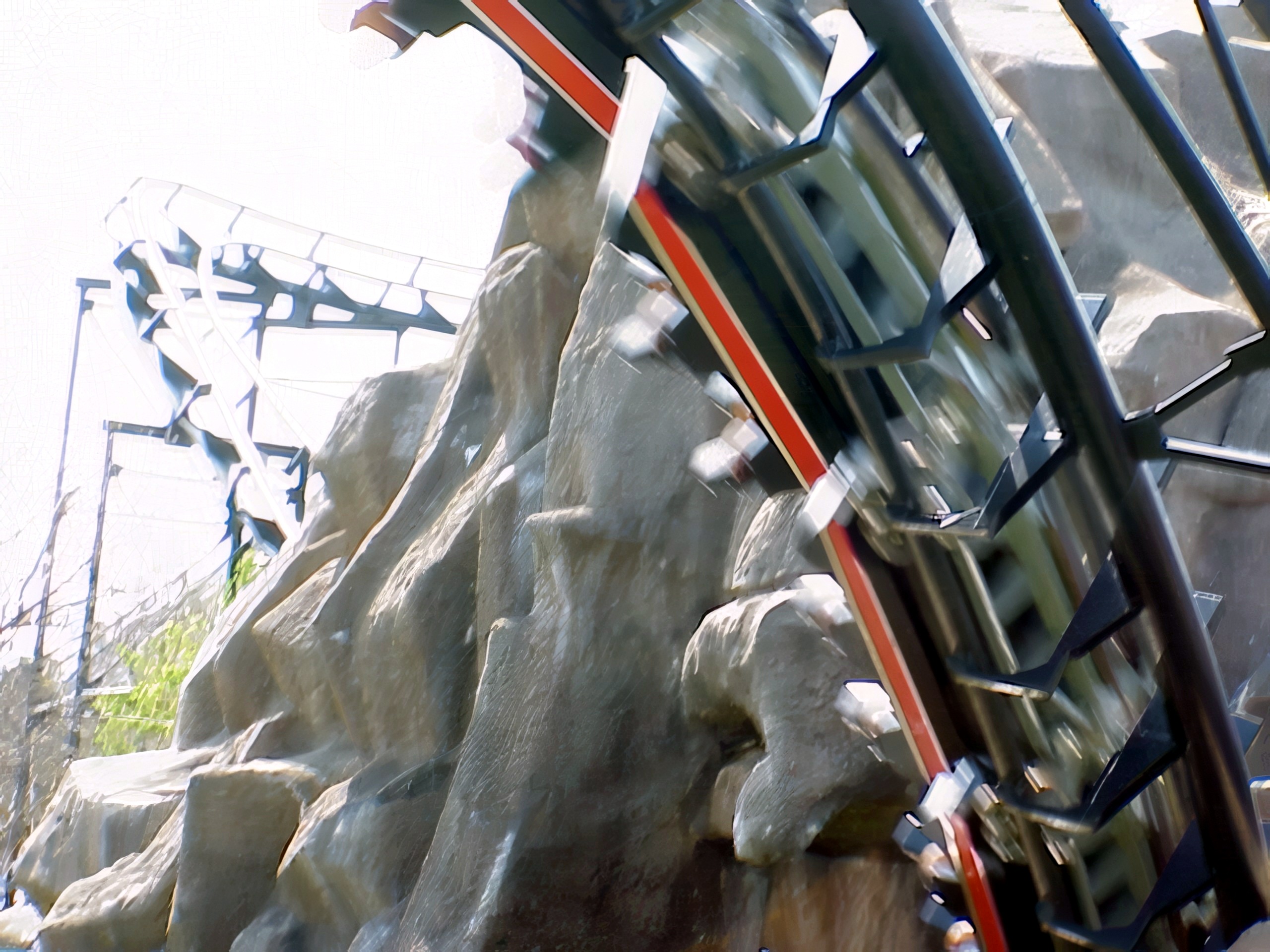 A Demon train racing past the artificial rock mountain at Six Flags Great America, April 2000