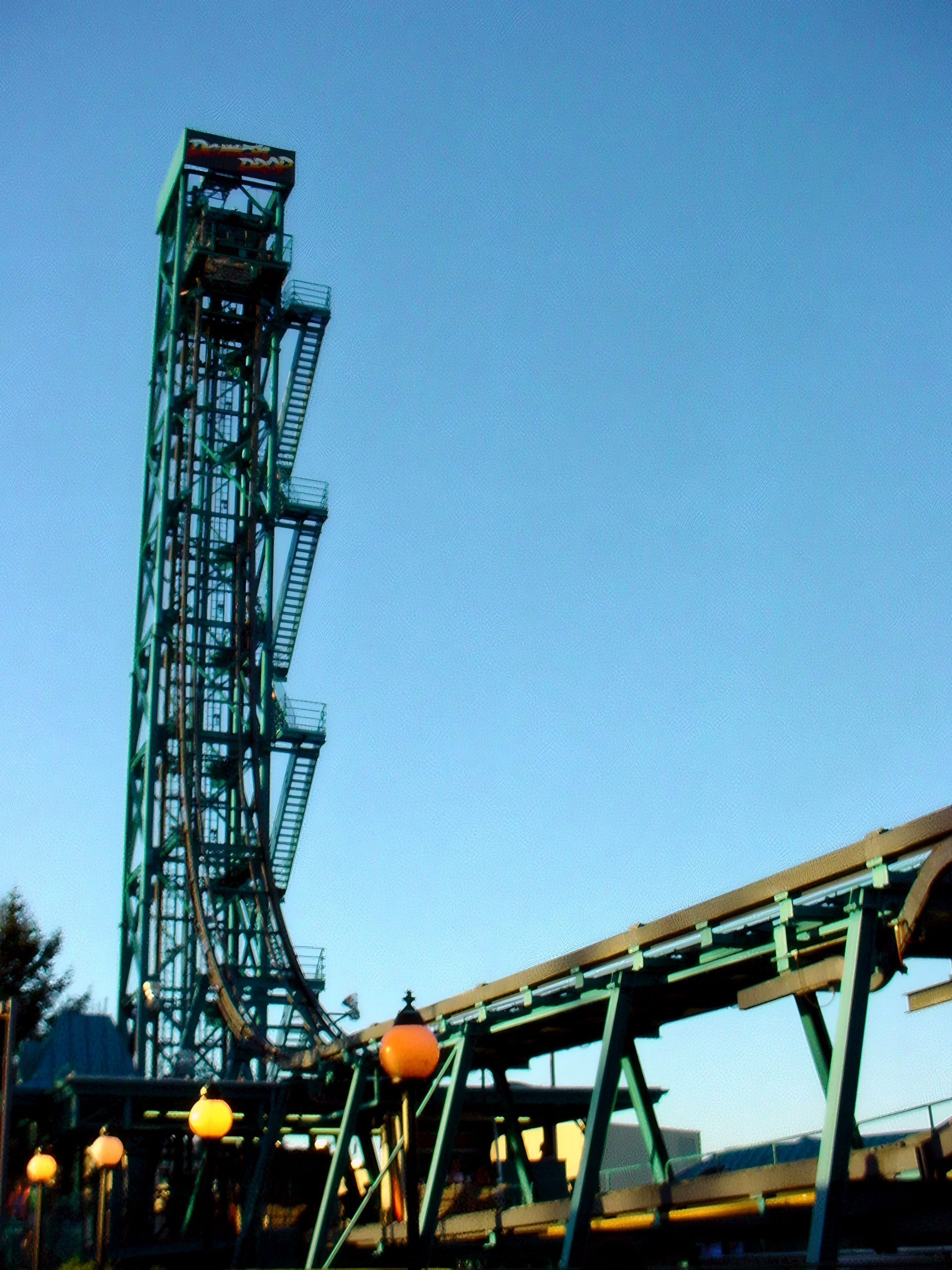 Demon Drop's tall green tower and curved drop track, at Cedar Point, July 2003