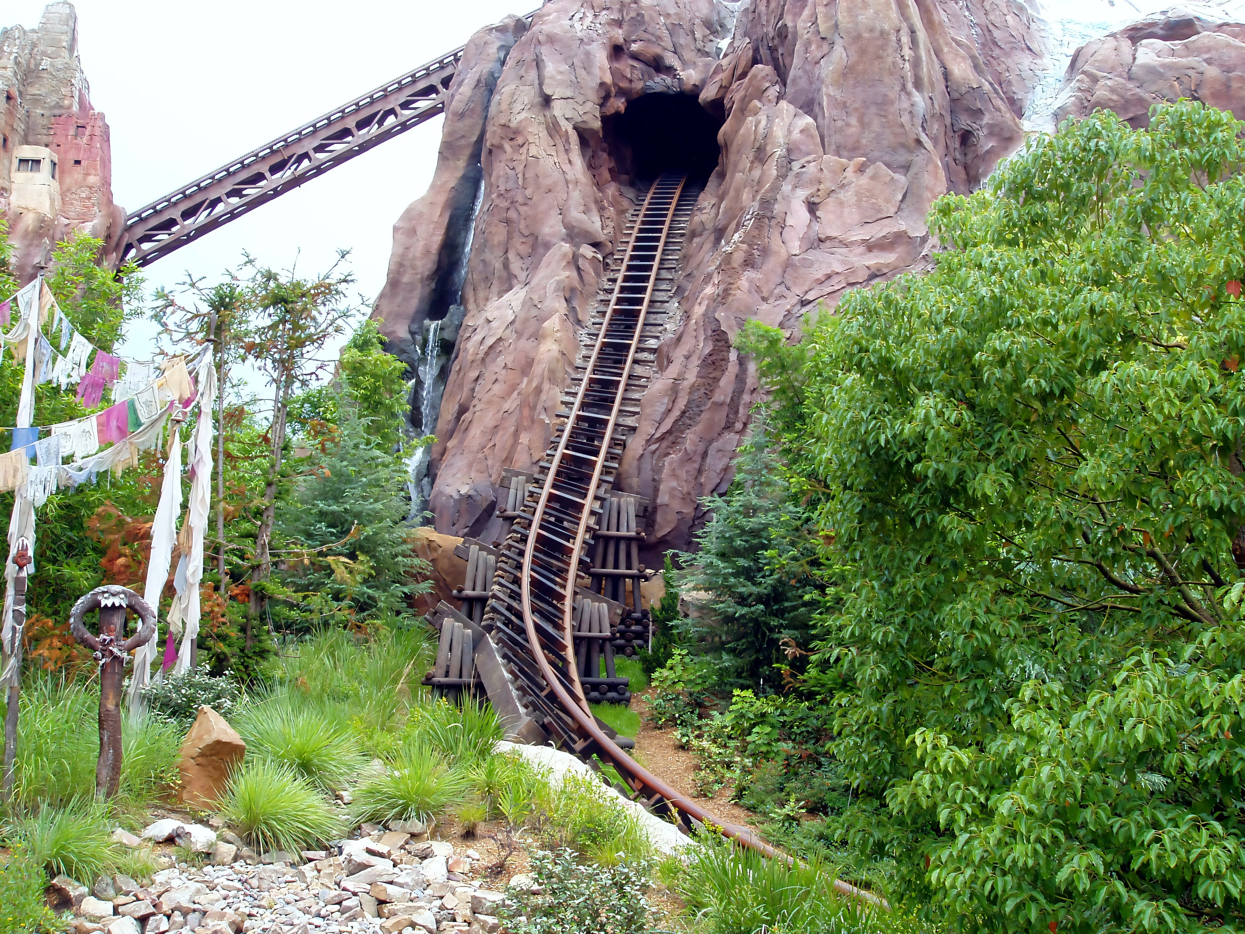 Coaster track and tunnel, prayer flags in foreground, Expedition Everest