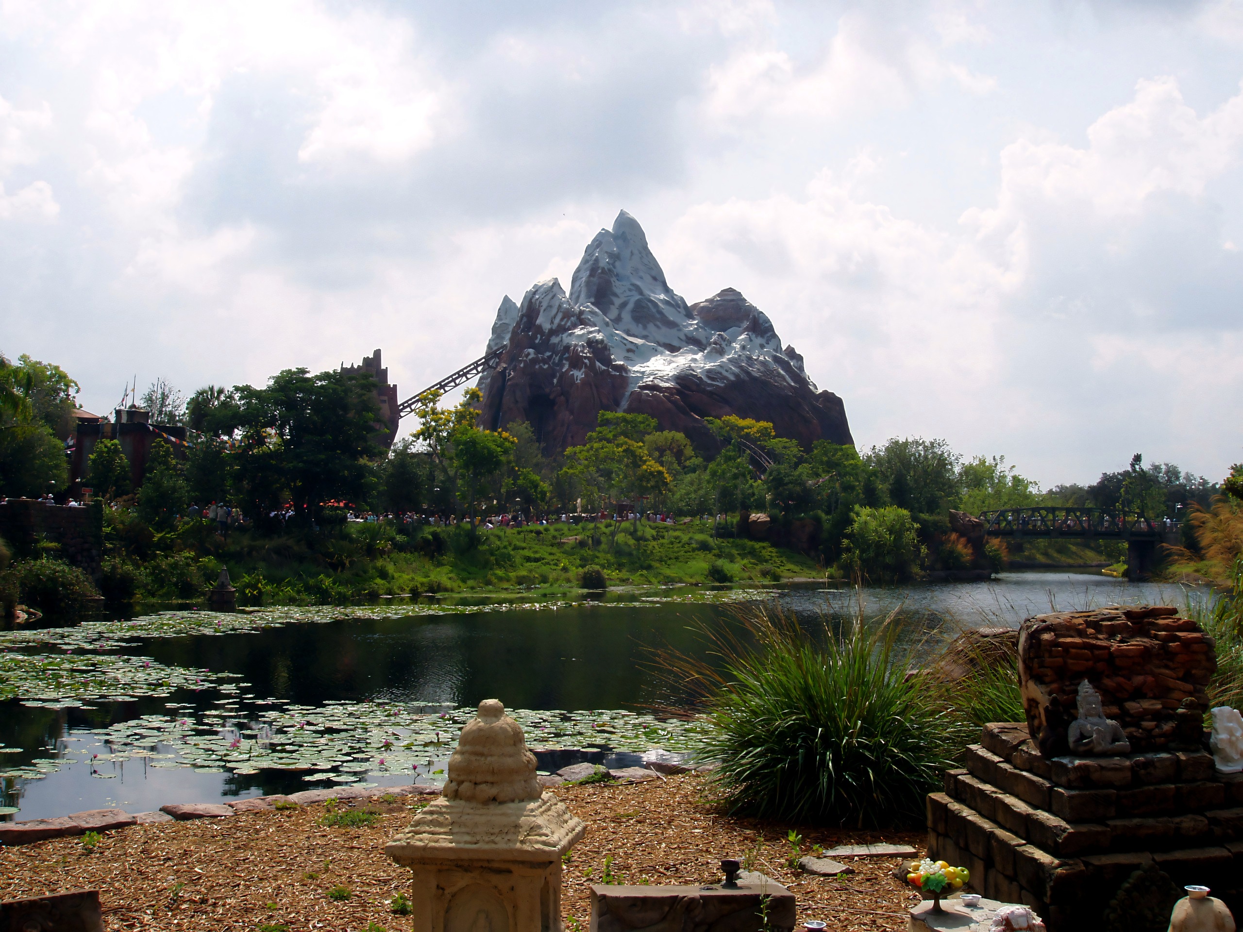 Coaster track winding around jagged mountain, pond foreground, Expedition Everest