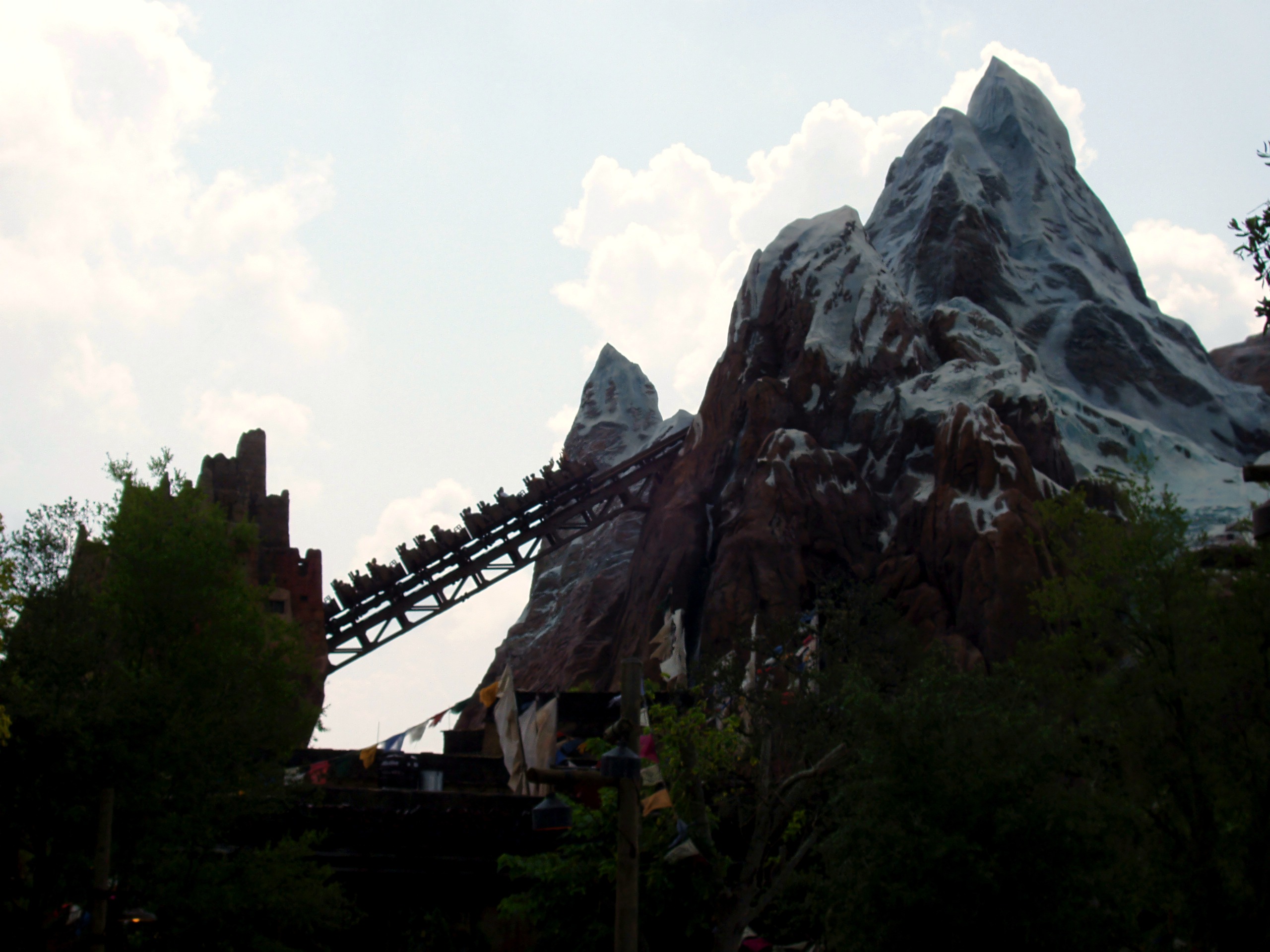 Coaster train climbing lift hill on rocky mountain, Expedition Everest