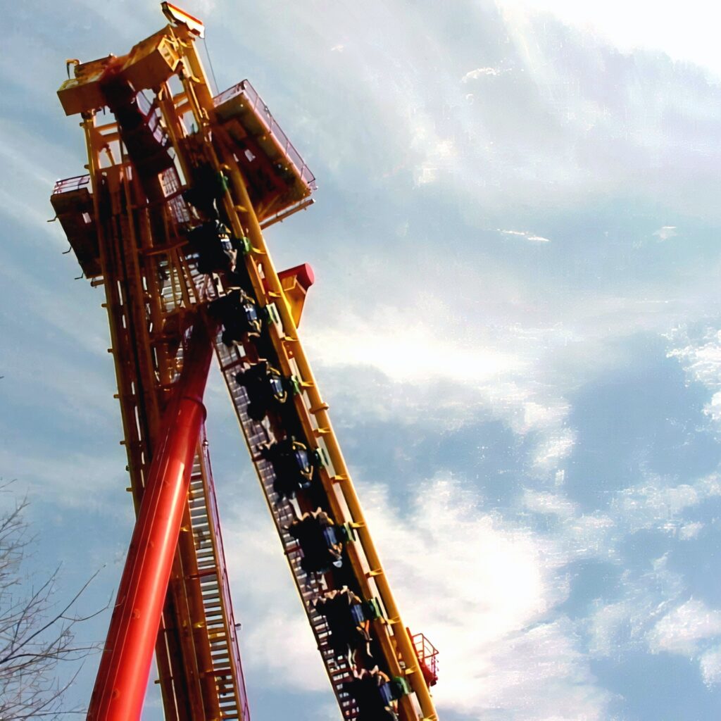 Face/Off (now Invertigo) at Kings Island: a train climbing the lift spike with riders facing each other