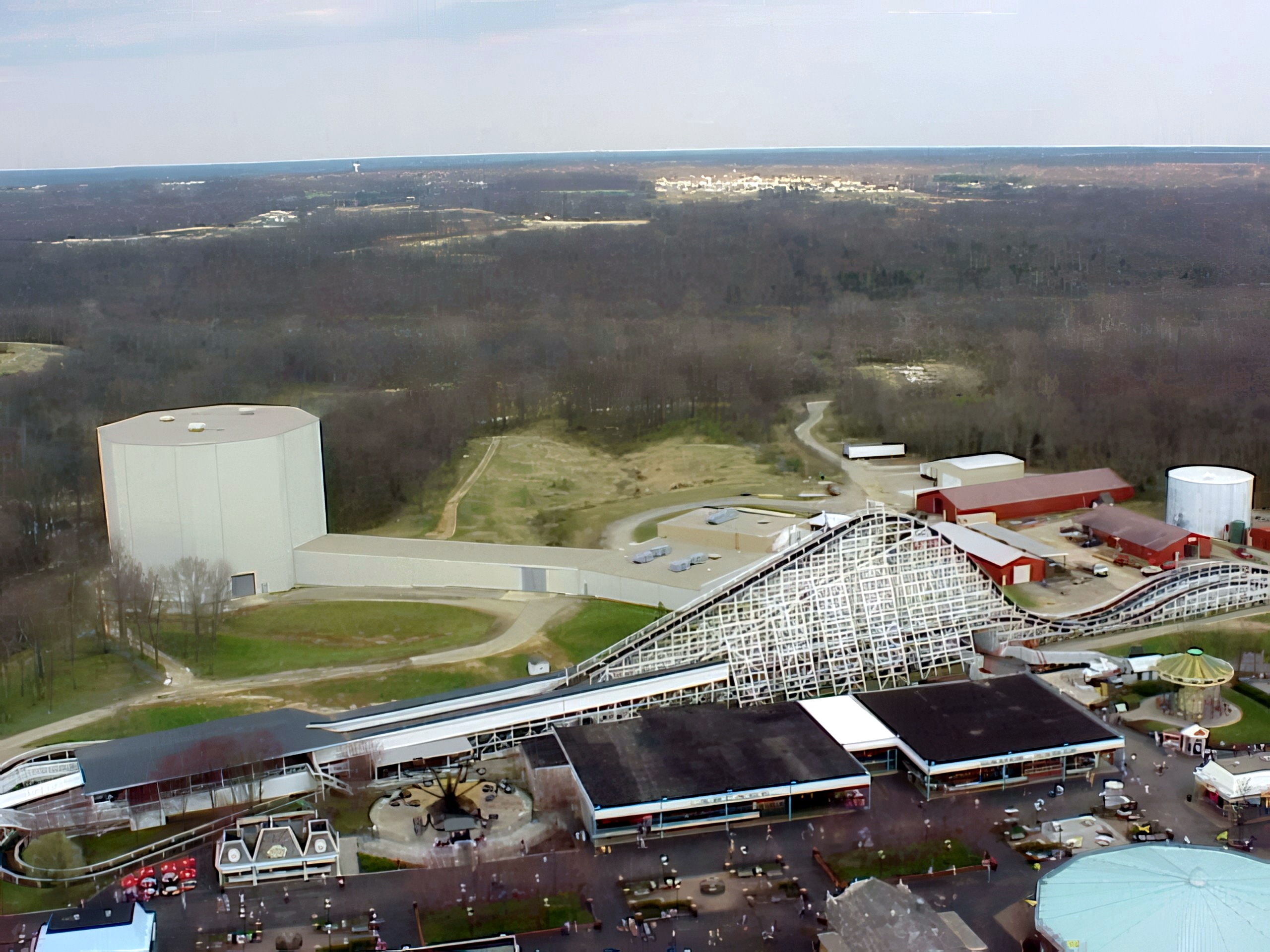 Aerial view of Racer coaster, water tower, and park midway, Flight of Fear, April 2001