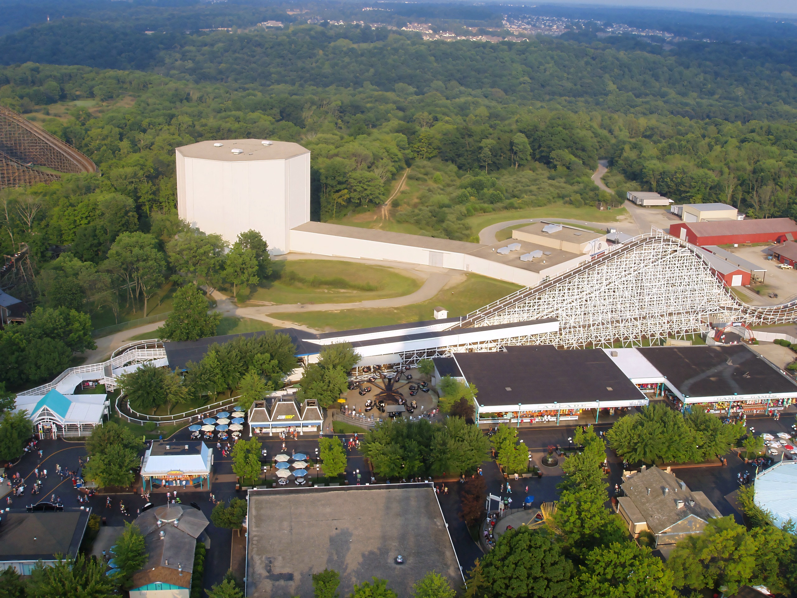 Aerial view of white wooden coaster, station, and water tower, Flight of Fear, August 2006