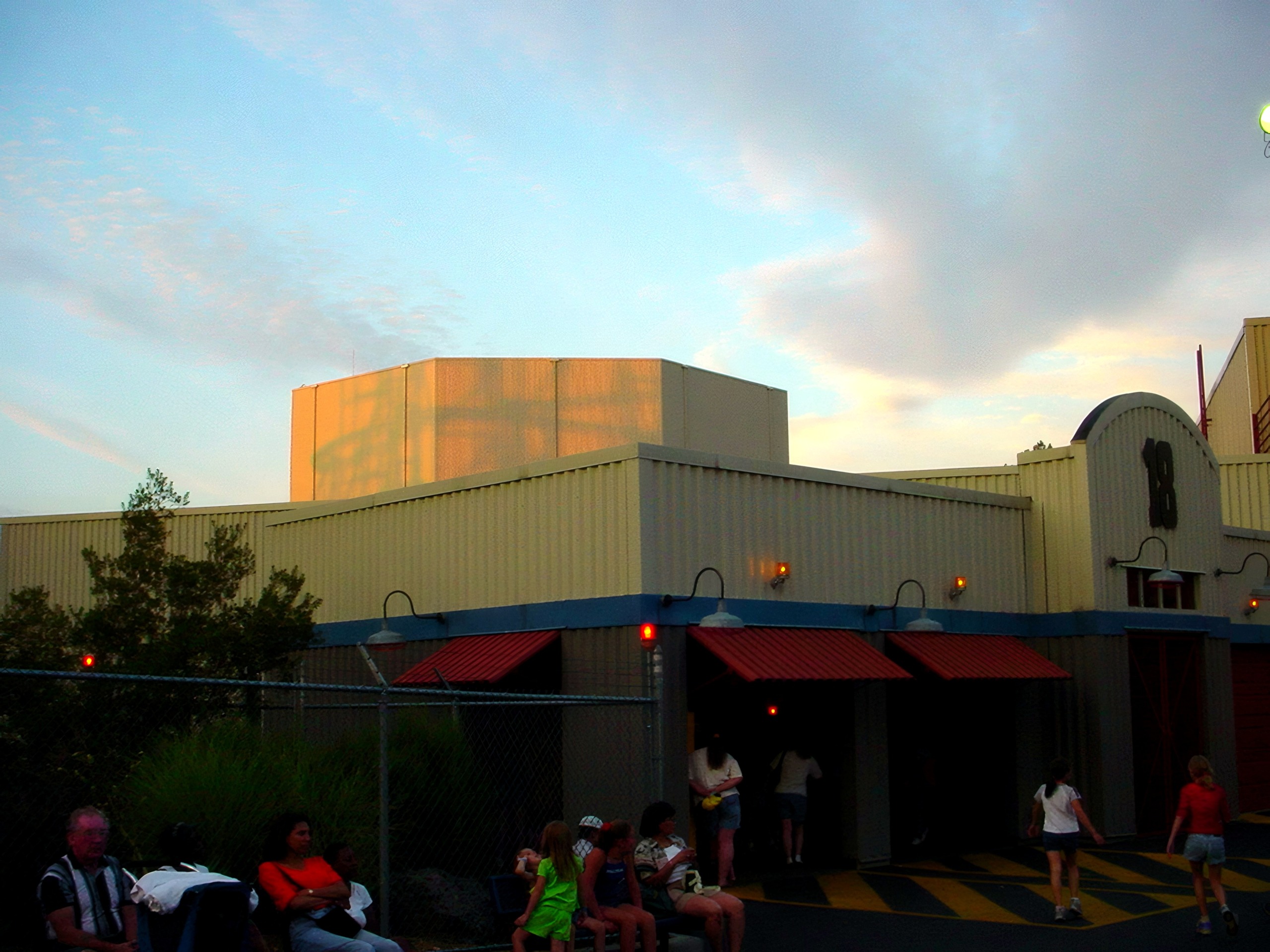 Ride entrance building numbered 18 with queue at dusk, Flight of Fear, July 2001