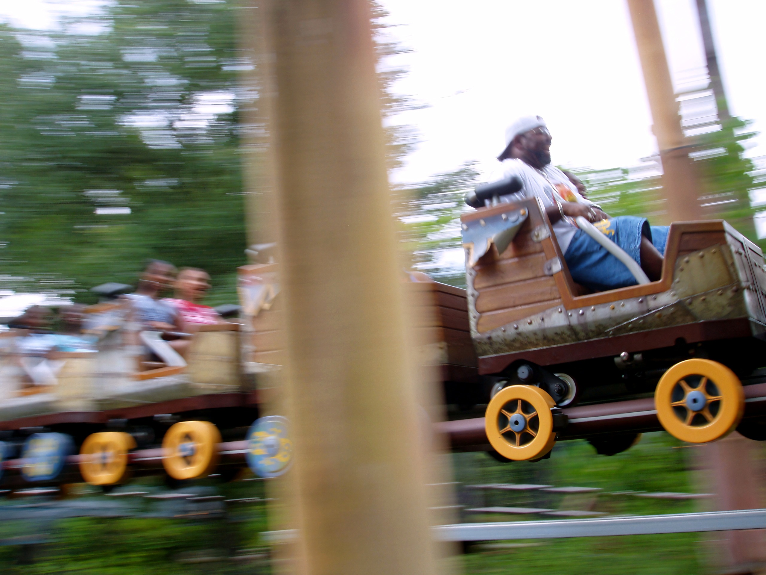 Motion-blurred train passing the queue, Flying Unicorn, July 2006