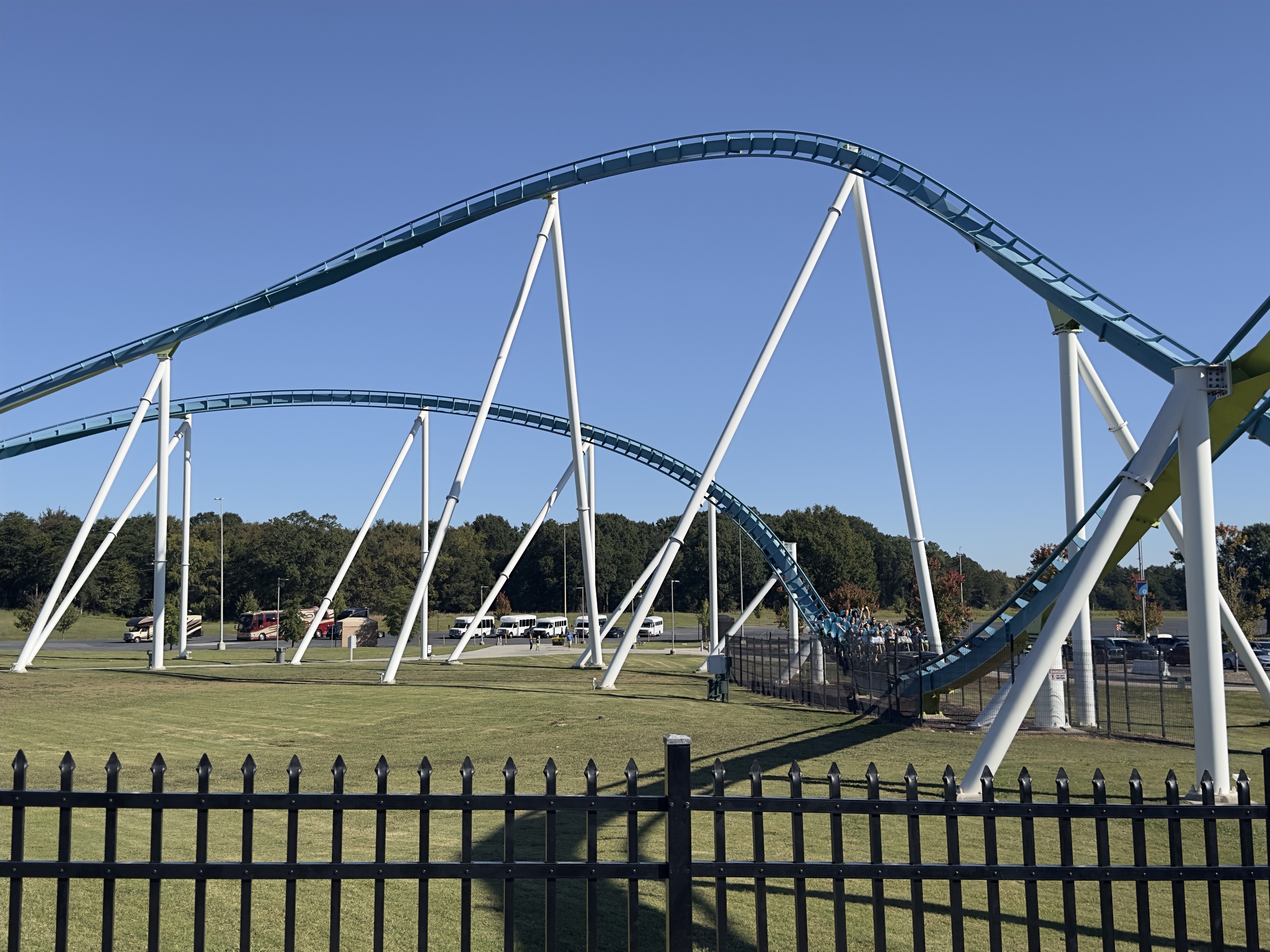 Fury 325's long teal airtime hills and white supports stretching over the lawn, Carowinds, October 2024