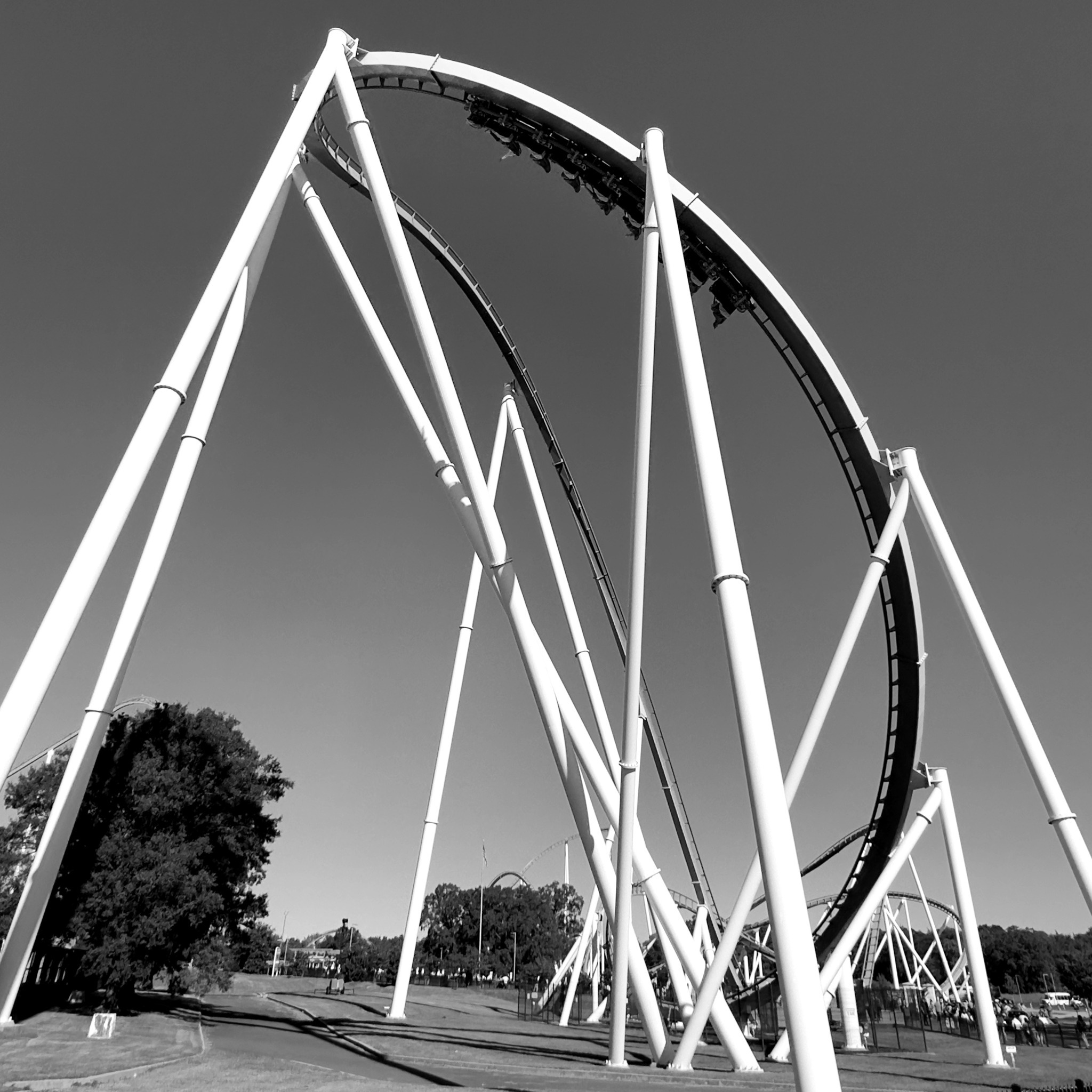 A Fury 325 train coming off the drop into the banked curve, black and white, Carowinds, October 2024