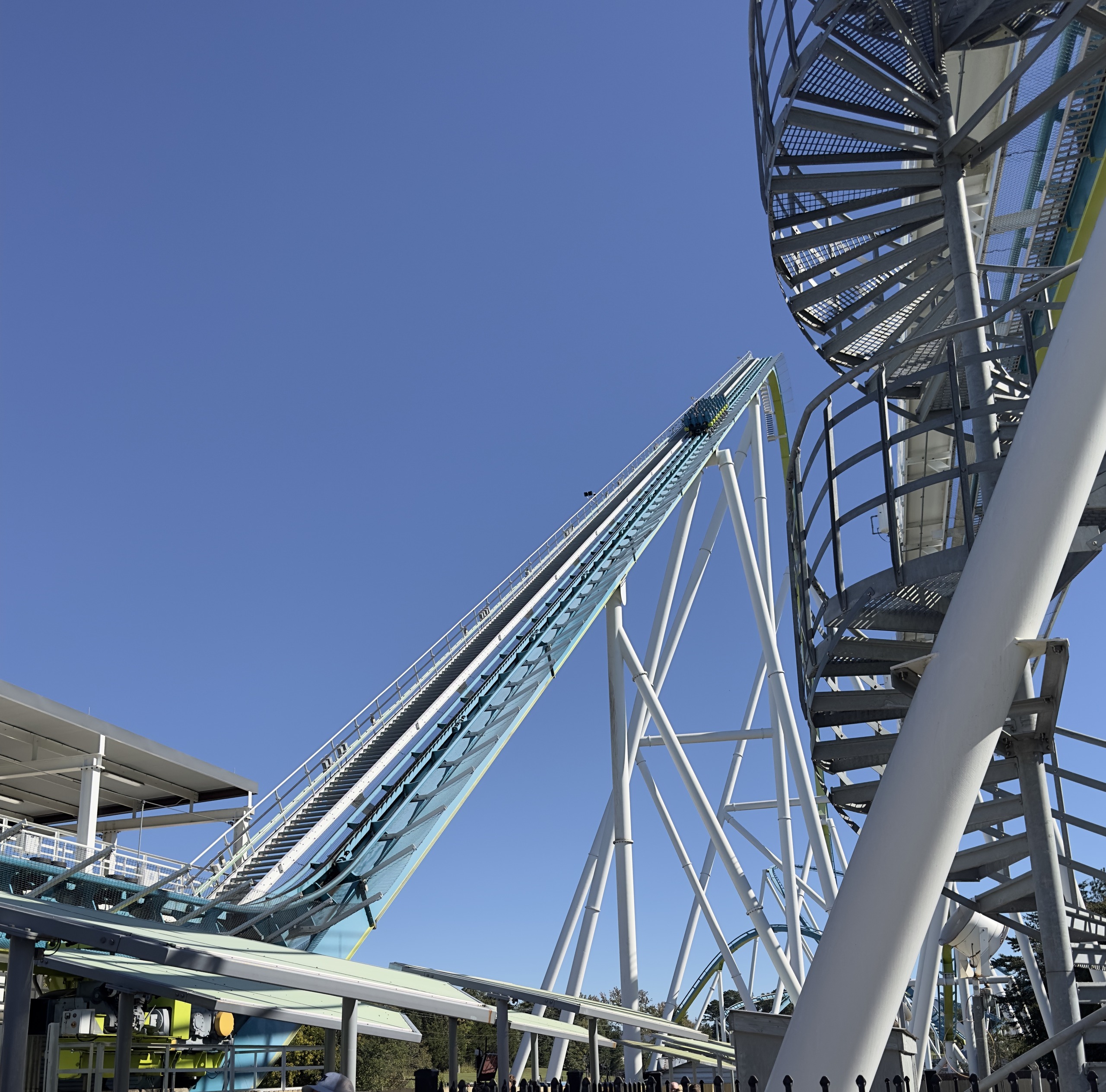 Fury 325's lift hill beside the station's spiral stair tower, Carowinds, October 2024