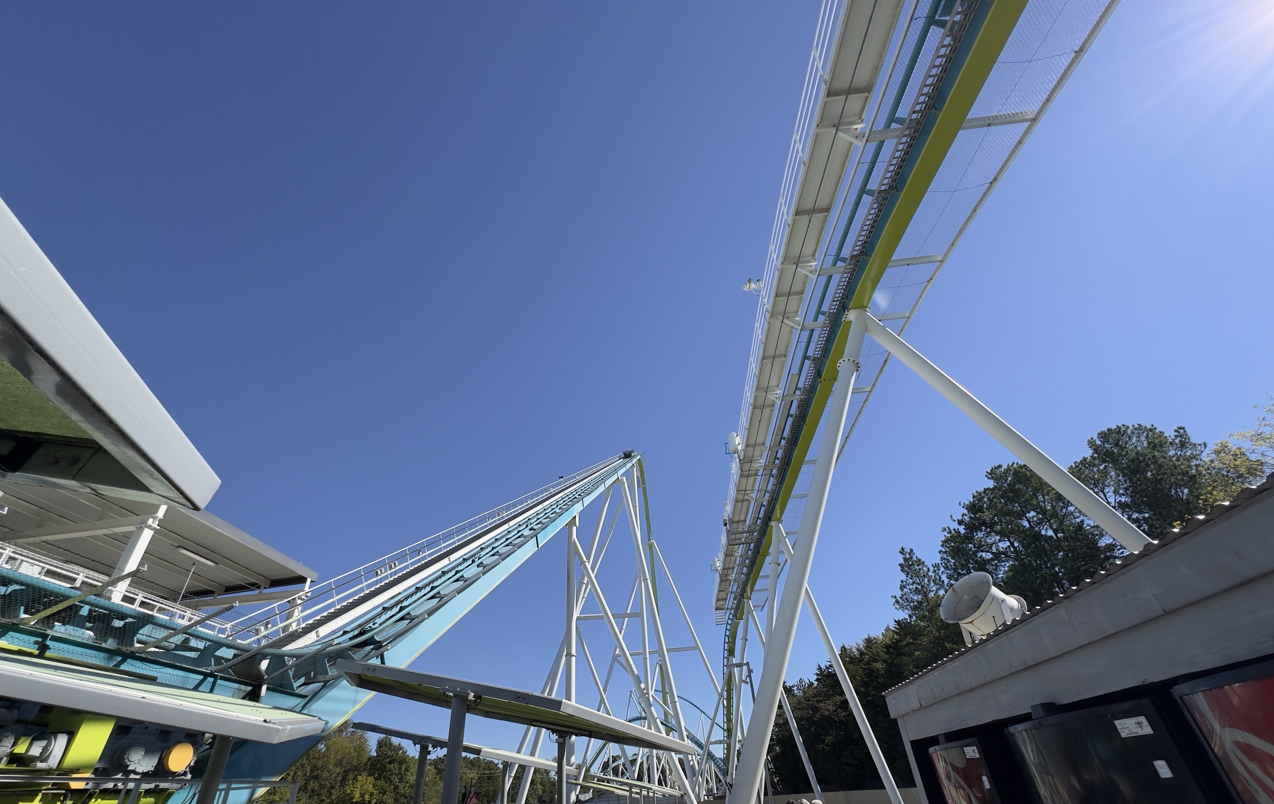 Fury 325's lift hill rising past the station roof in the sun, Carowinds, October 2024