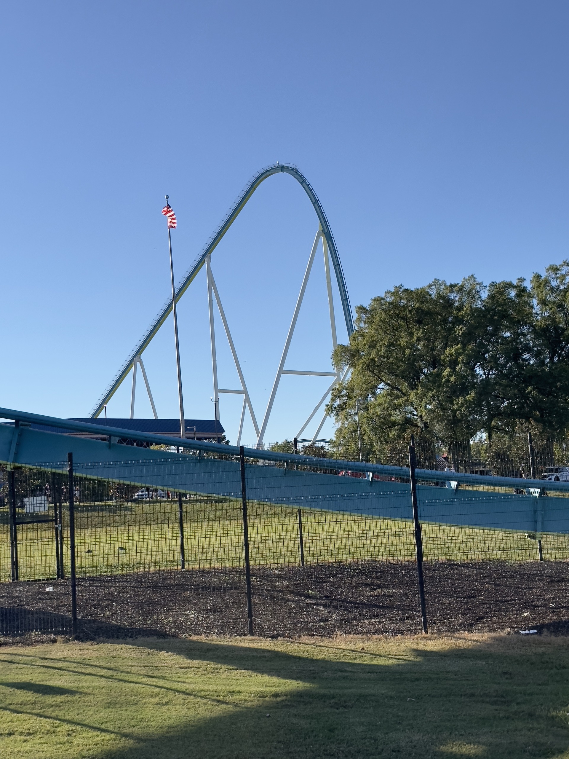Fury 325's lift hill and flag from the lawn by the turnaround, Carowinds, October 2024