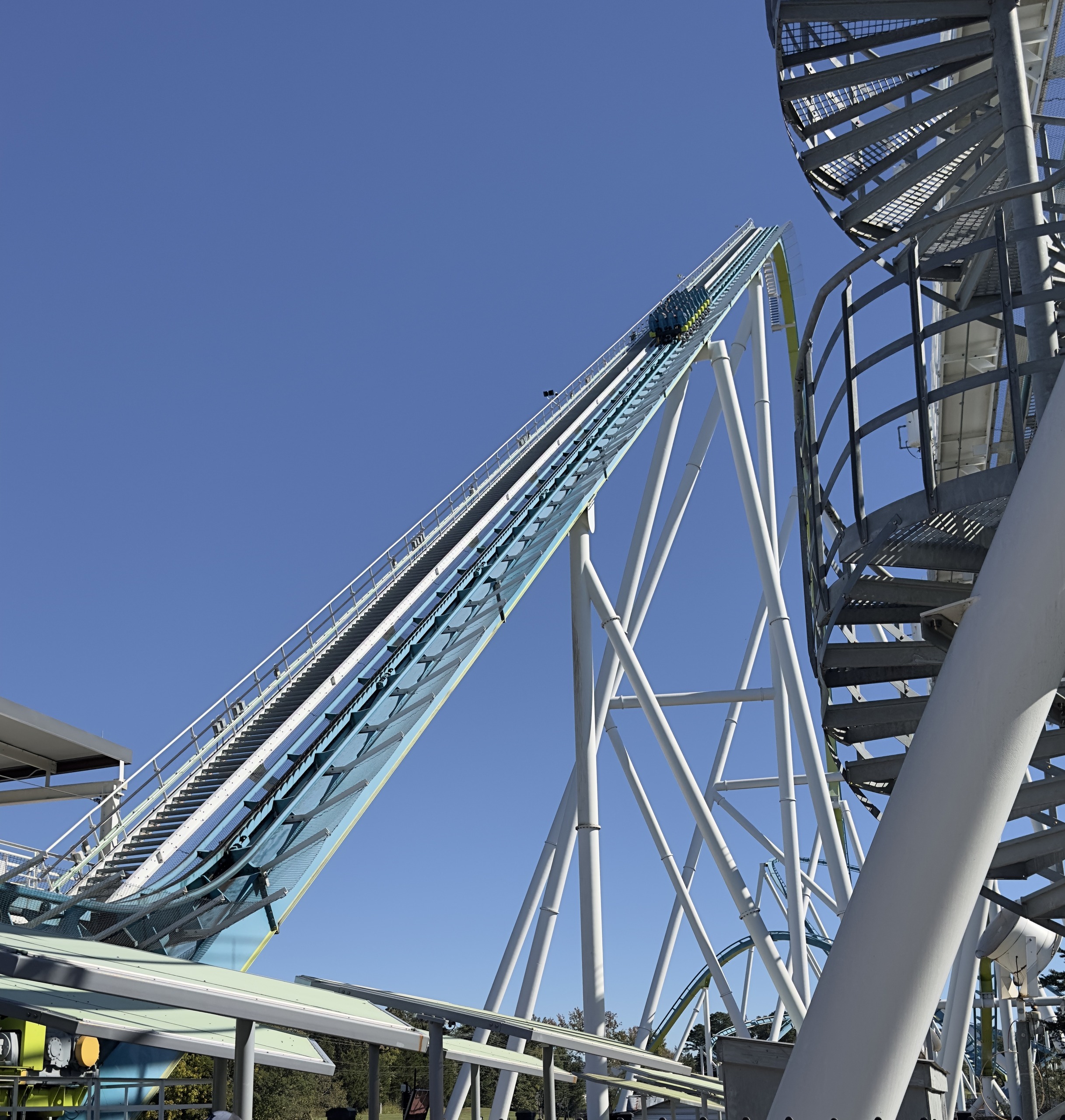 Looking up Fury 325's lift hill from the queue beside the spiral stairs, Carowinds, October 2024