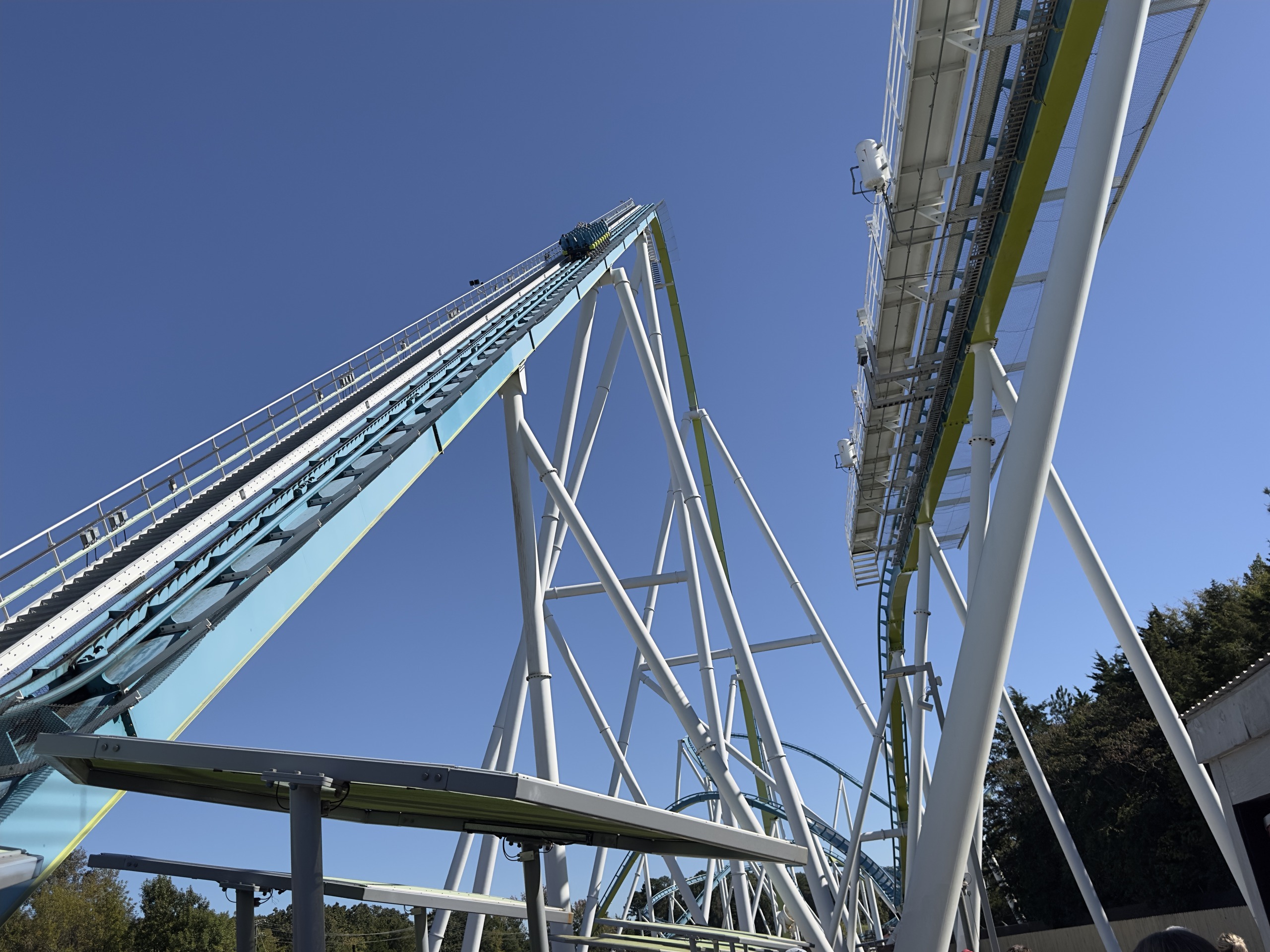 Fury 325's lift hill and white truss supports from below the station, Carowinds, October 2024