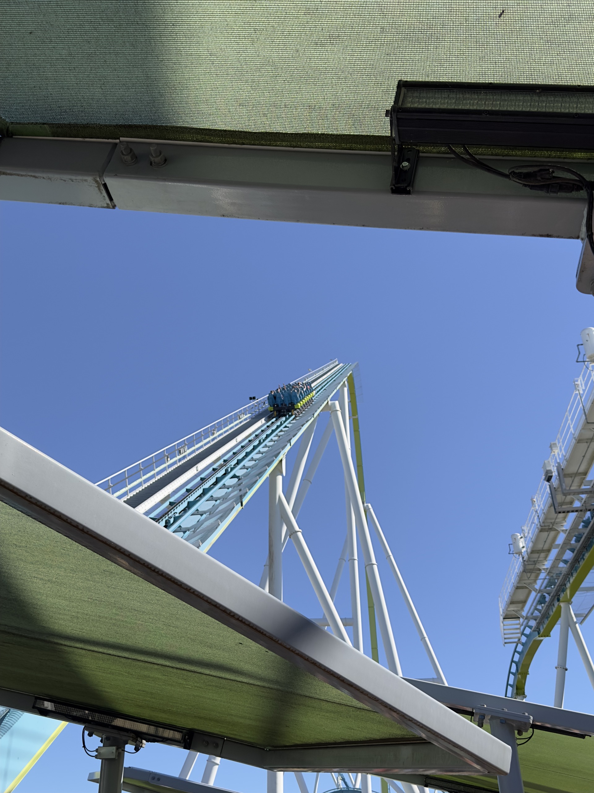 A Fury 325 train on the lift framed by the queue canopy, Carowinds, October 2024