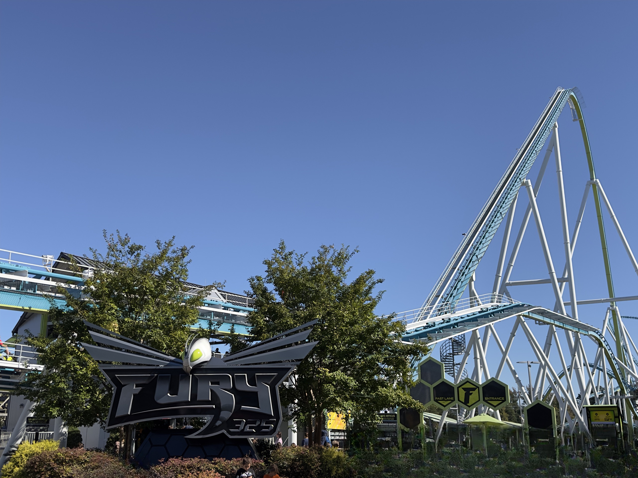 The winged Fury 325 sign in front of the white lift structure and hexagon entrance markers, Carowinds, October 2024