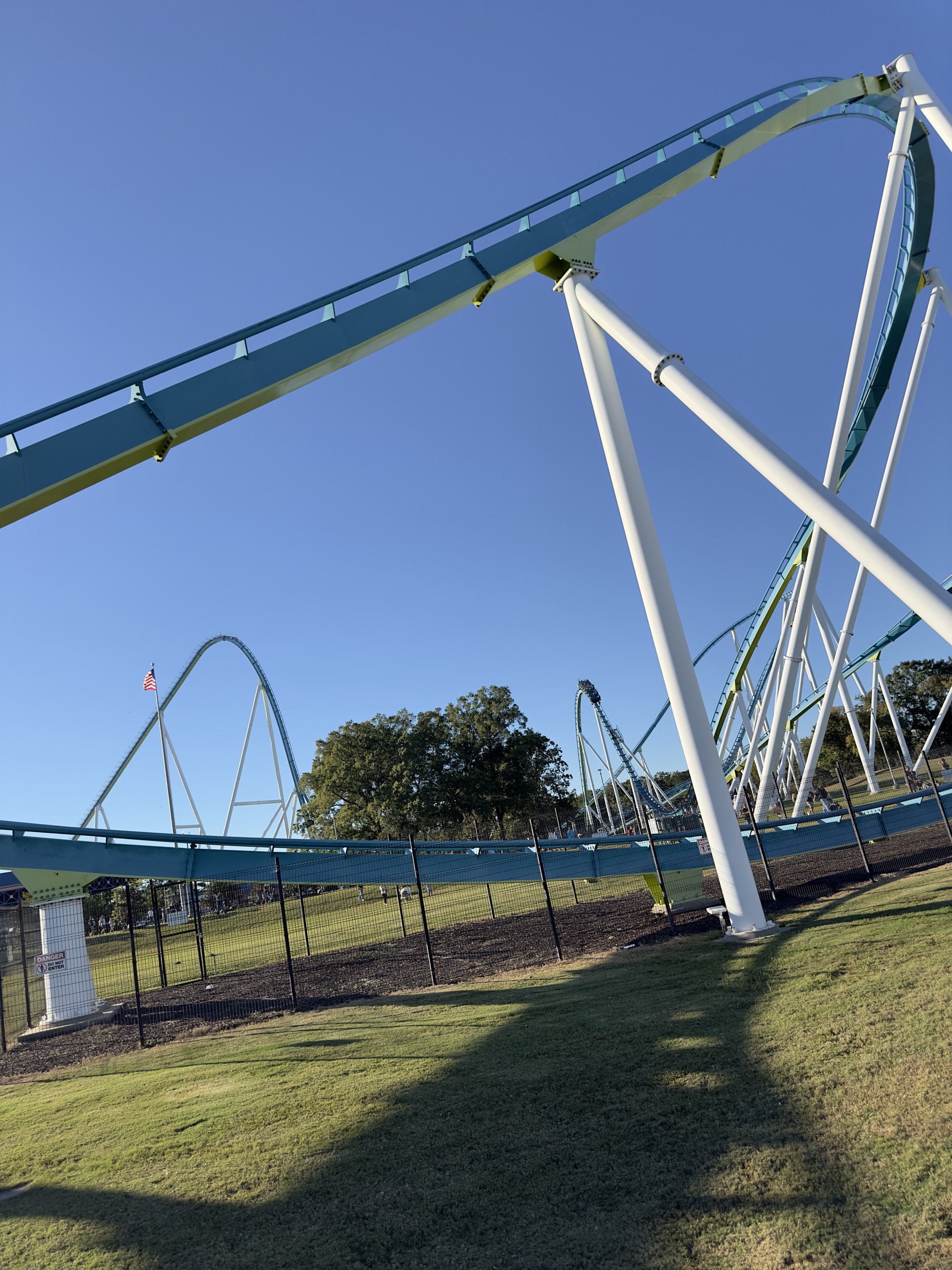 Fury 325's teal track sweeping over a white support, the lift hill in the distance, Carowinds, October 2024