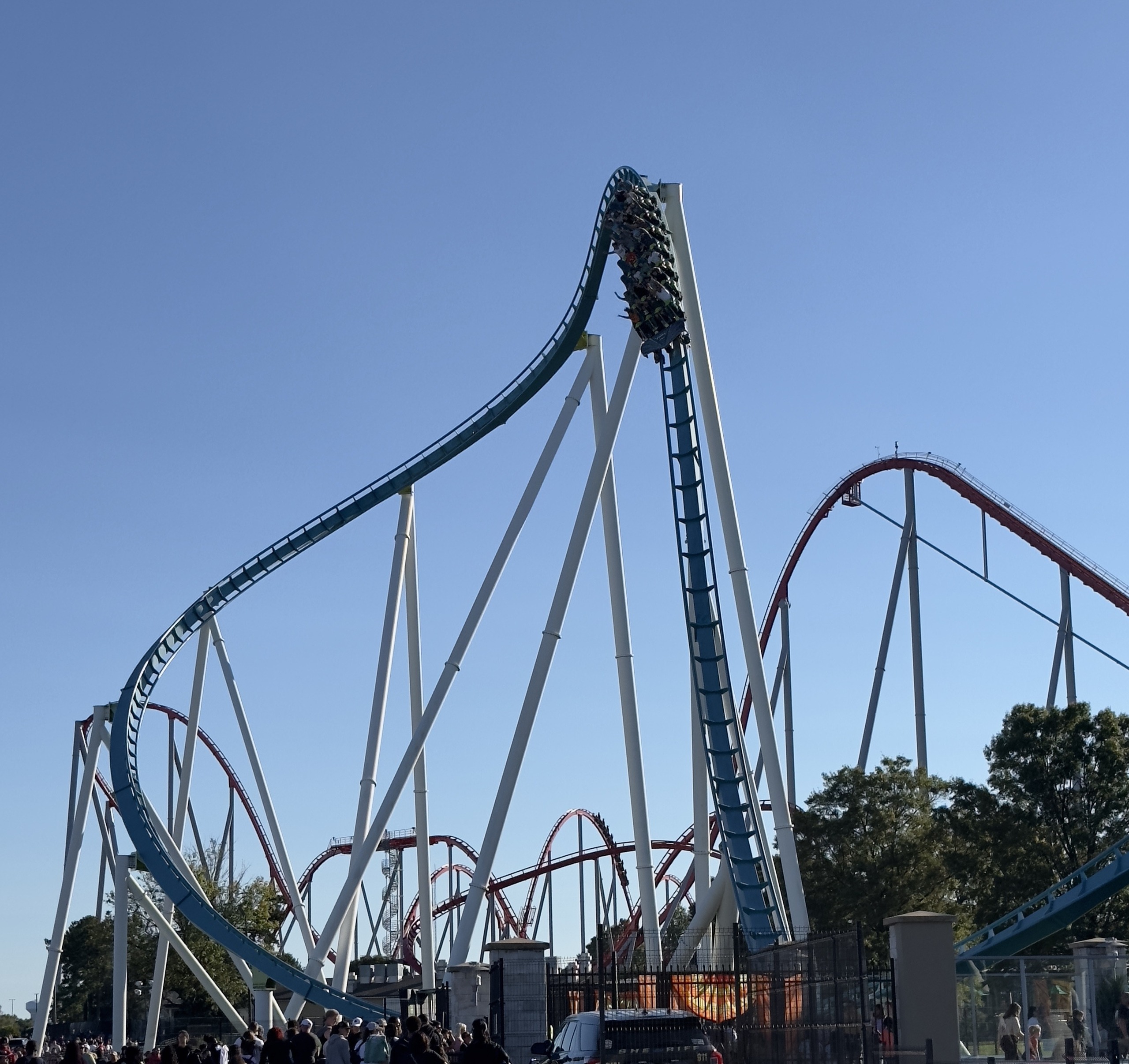 A Fury 325 train heading down the drop with Thunder Striker's red track behind, Carowinds, October 2024