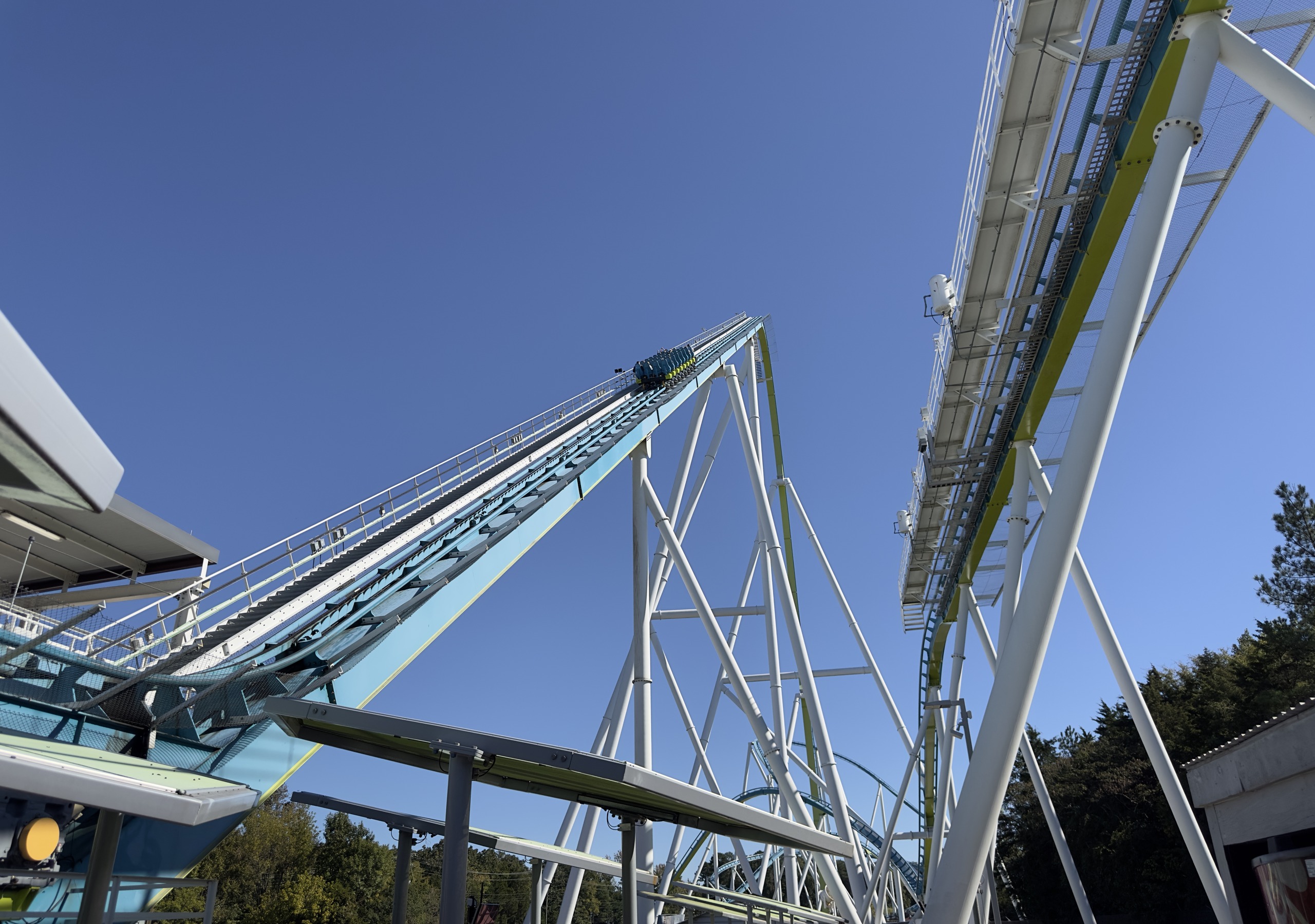 A Fury 325 train climbing the 325-foot lift hill seen from under the station, Carowinds, October 2024