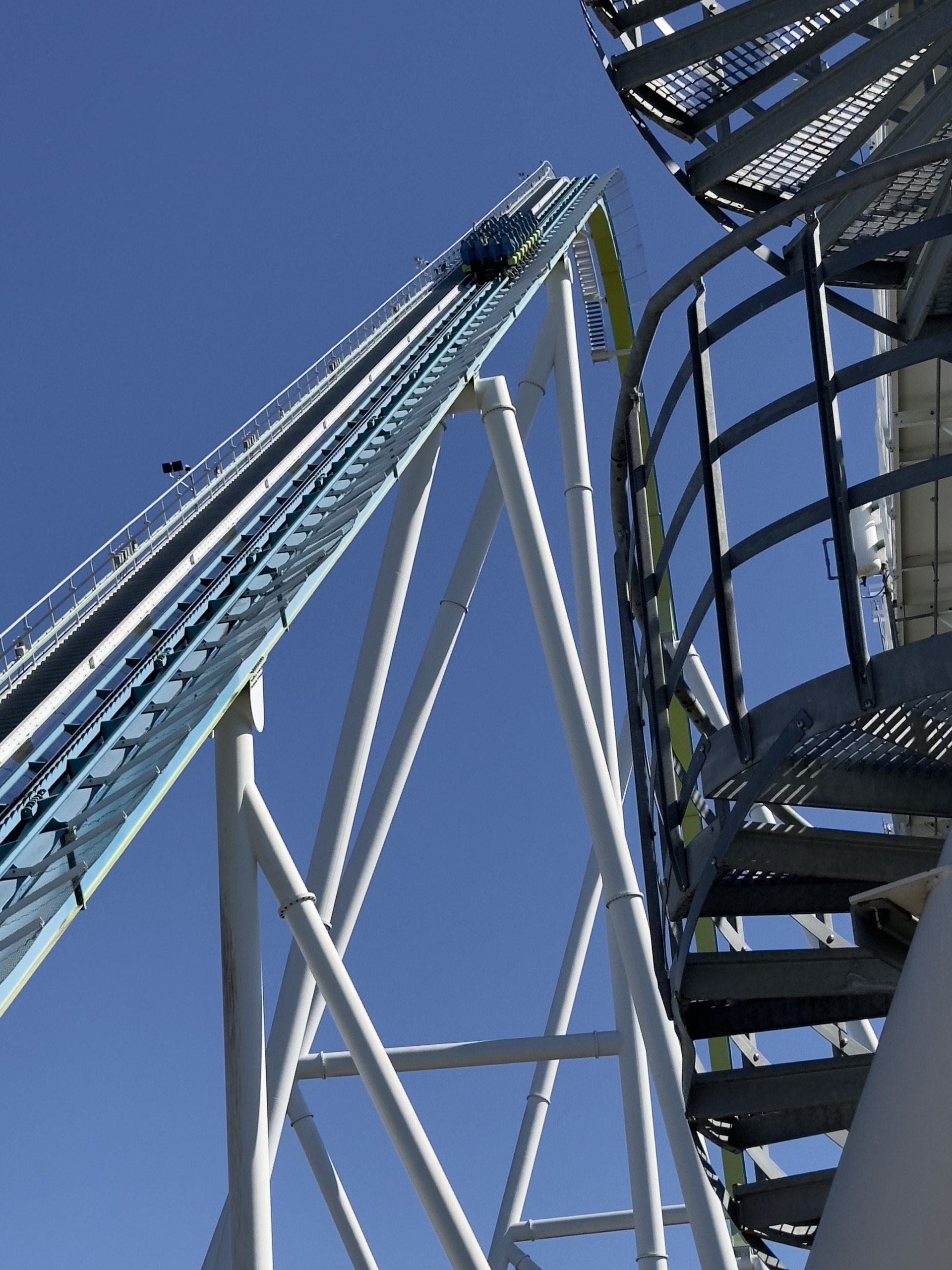 A Fury 325 train starting up the lift next to the spiral stairs, Carowinds, October 2024