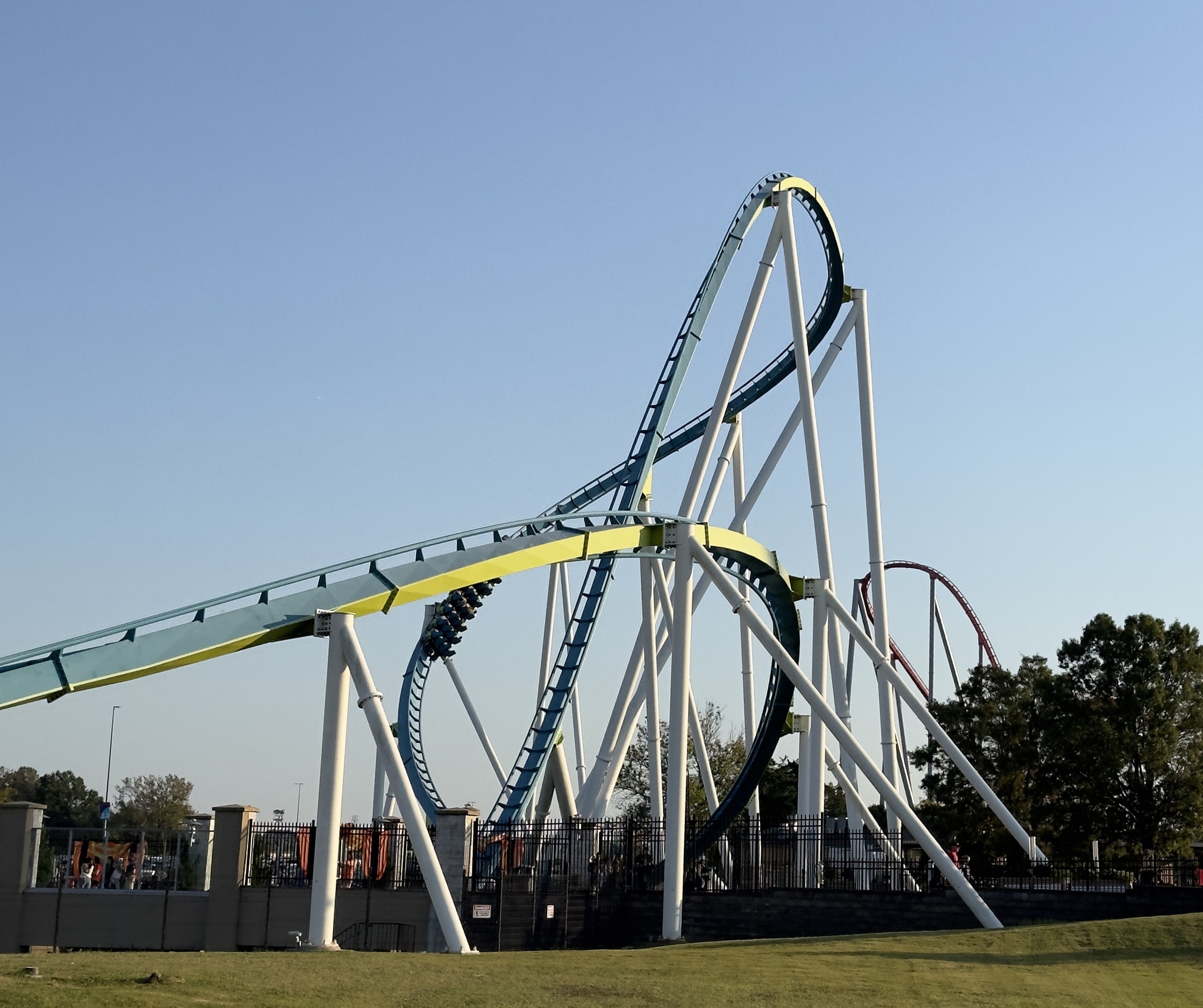 Fury 325's banked turnaround and lift crest from the lawn in late-afternoon light, Carowinds, October 2024