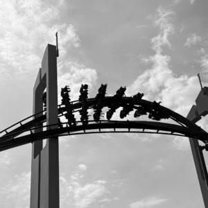 A GateKeeper wing coaster train silhouetted through the keyhole tower at Cedar Point, black and white