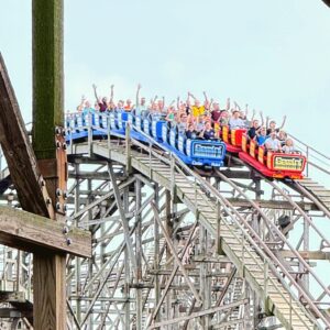 Gemini's red and blue trains cresting the hill side by side at Cedar Point, September 2026