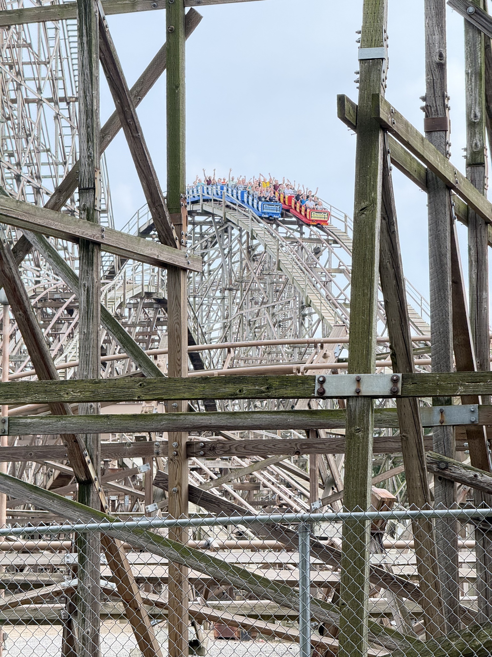 Gemini's racing trains cresting the hill together, framed by the wooden structure