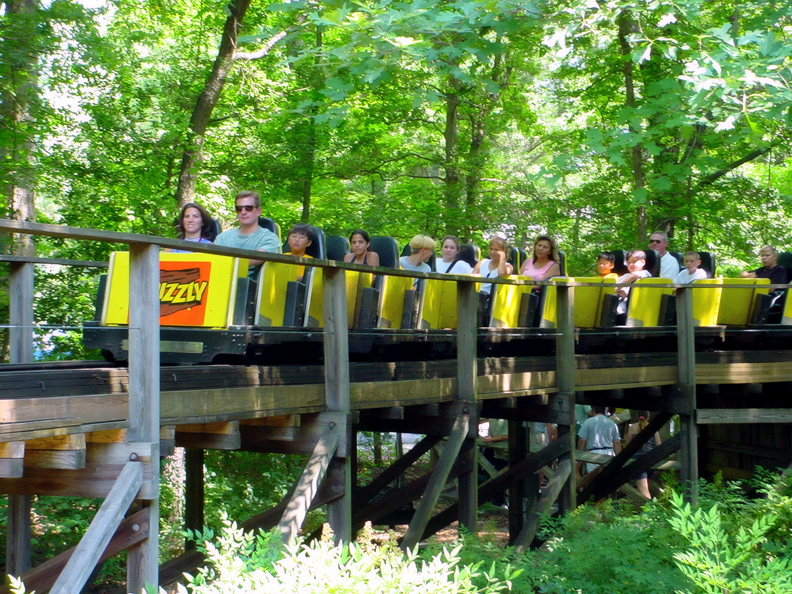 Riders on a yellow Grizzly train on the wooden trestle at Kings Dominion, July 2001