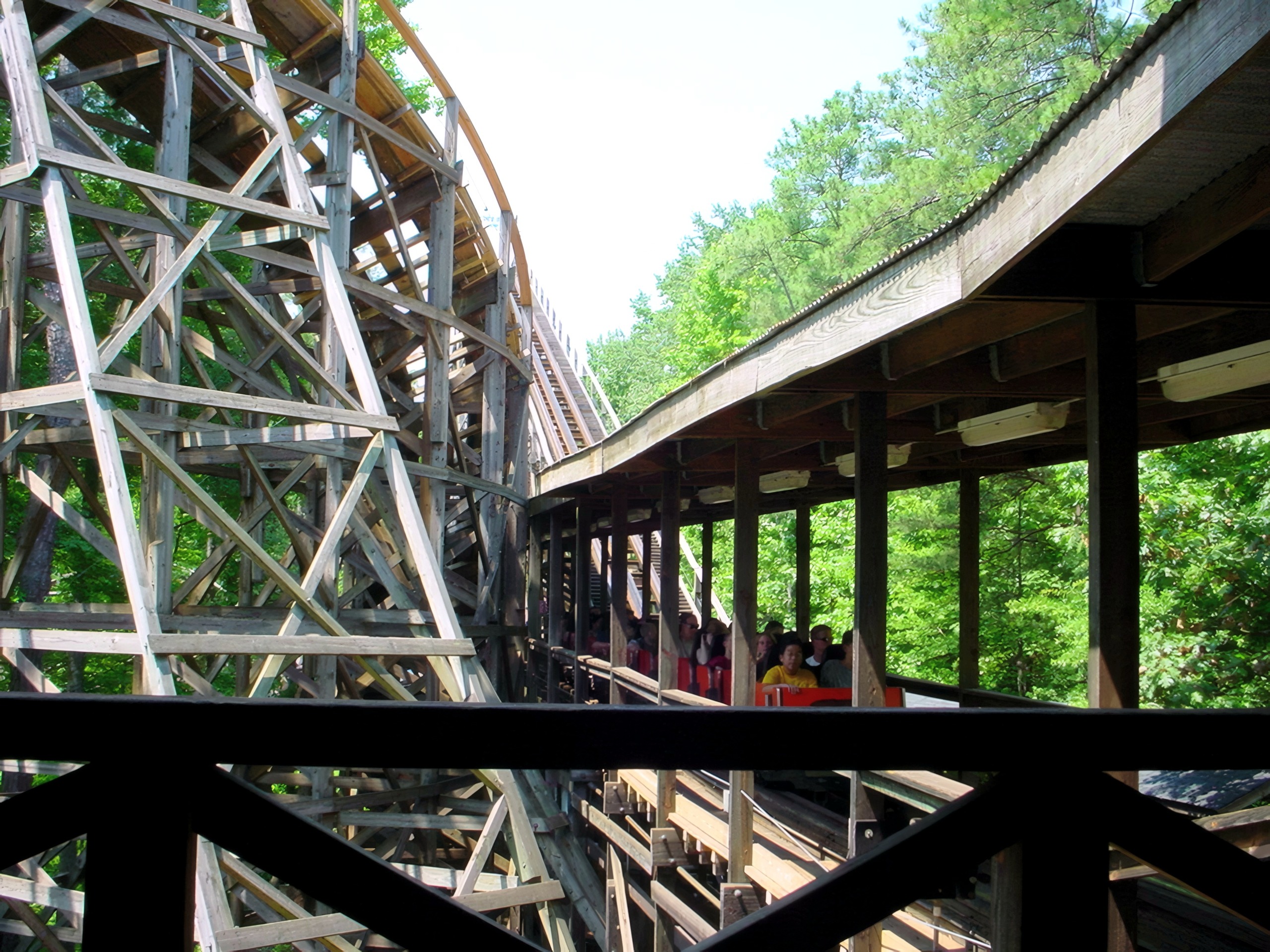 A yellow Grizzly train loading in the wooden station at Kings Dominion, July 2001