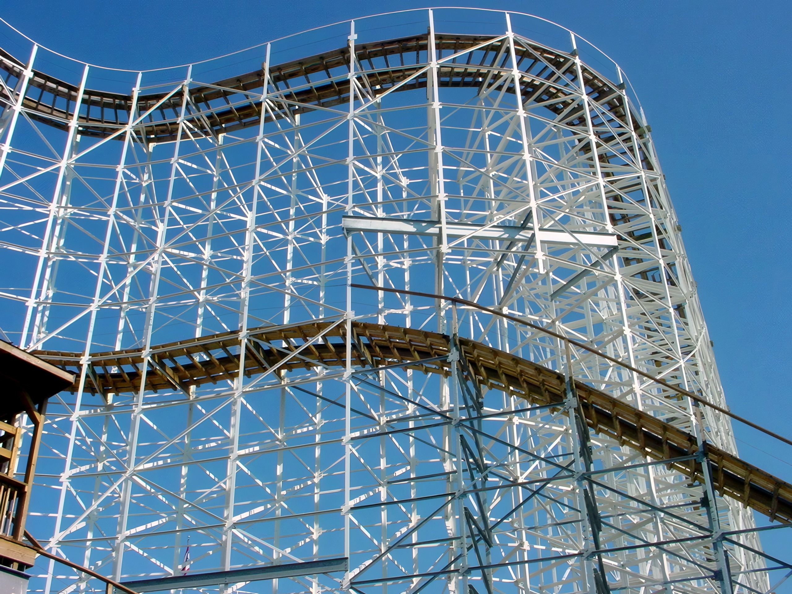 Hoosier Hurricane's wooden track curve on white steel supports against a clear sky, June 2002