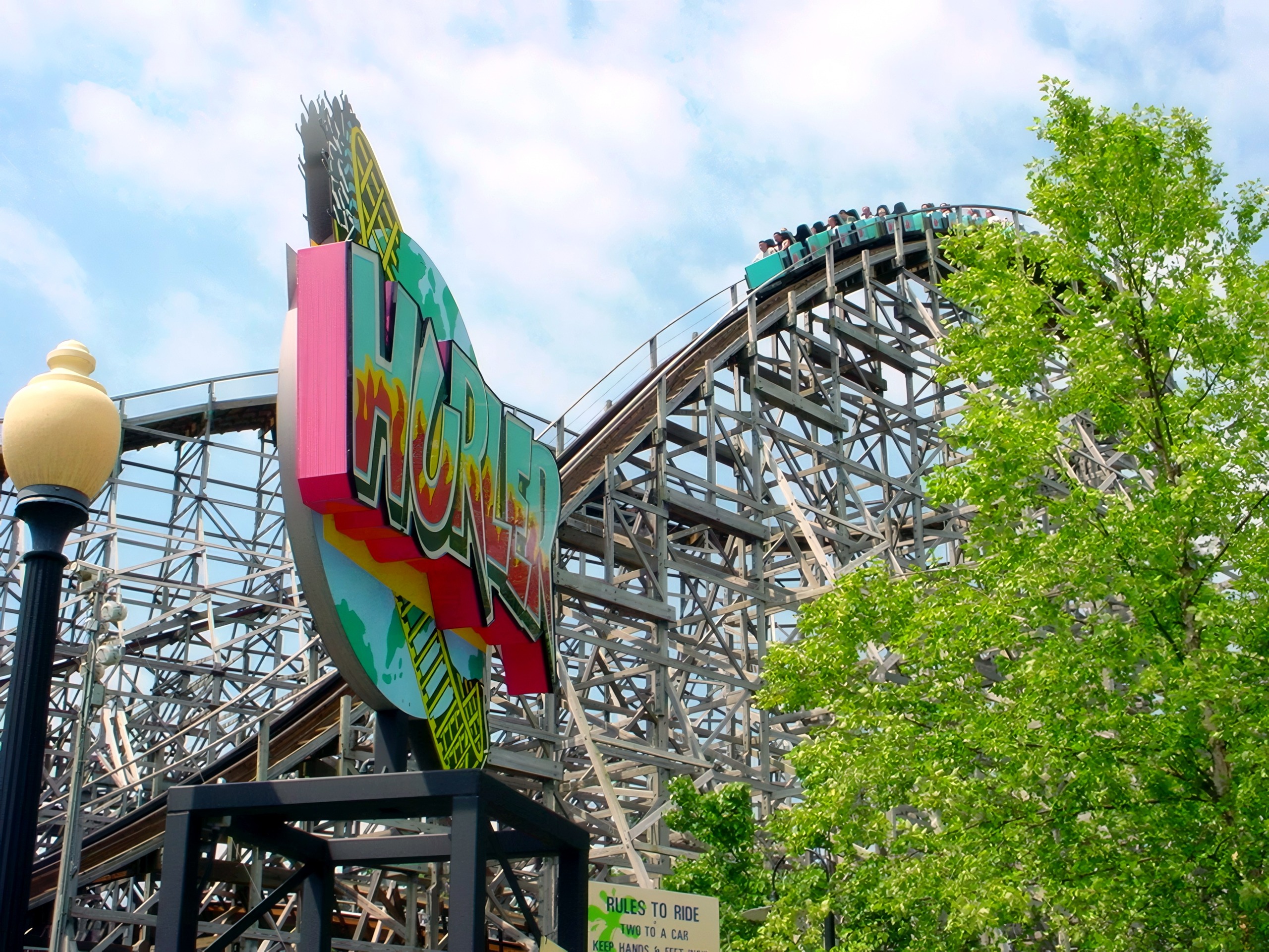 The Hurler sign with the wooden lift hill and a train behind it at Kings Dominion, July 2001
