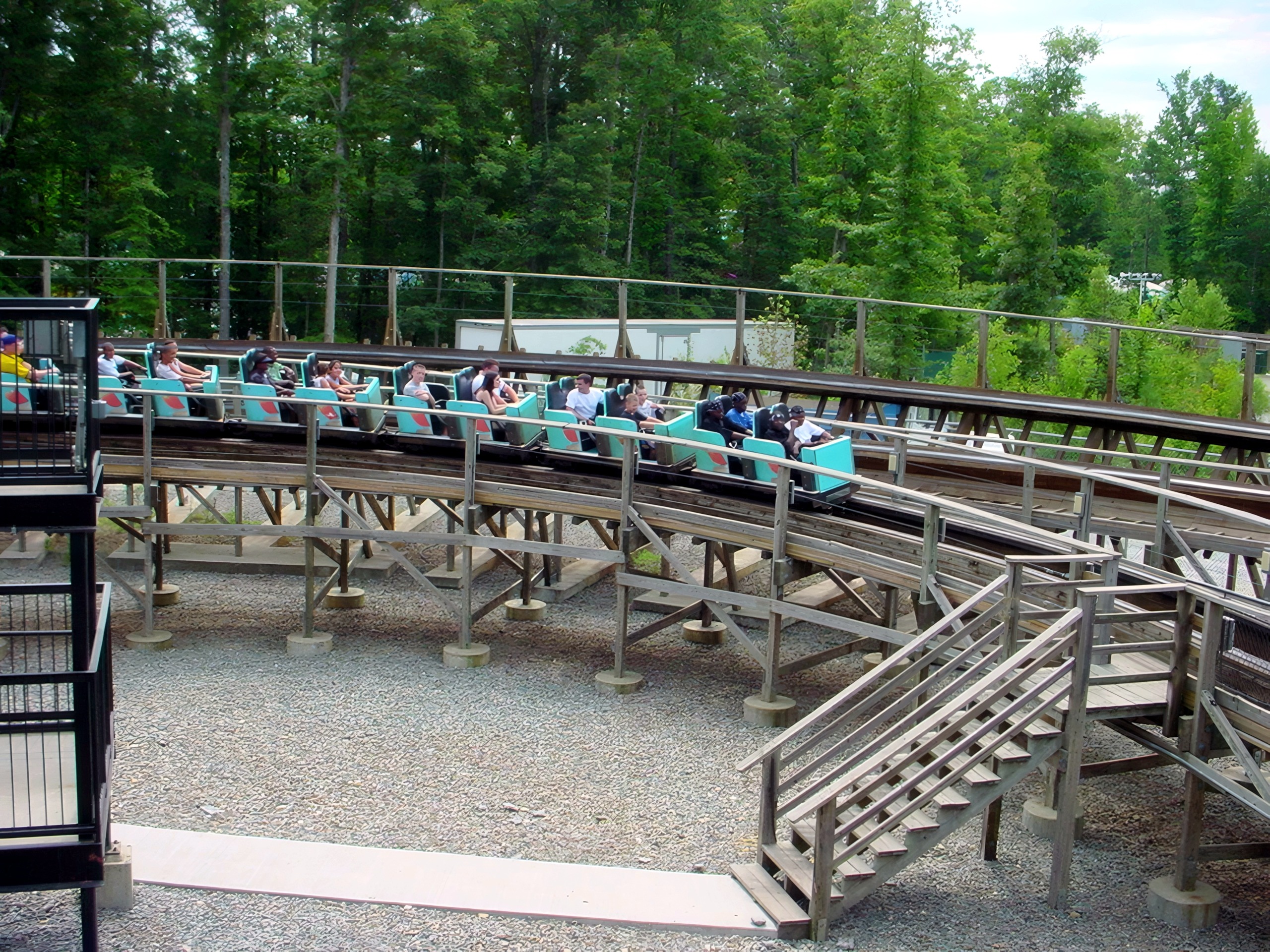 A teal Hurler train loading in the station beside the wooden structure at Kings Dominion, July 2001
