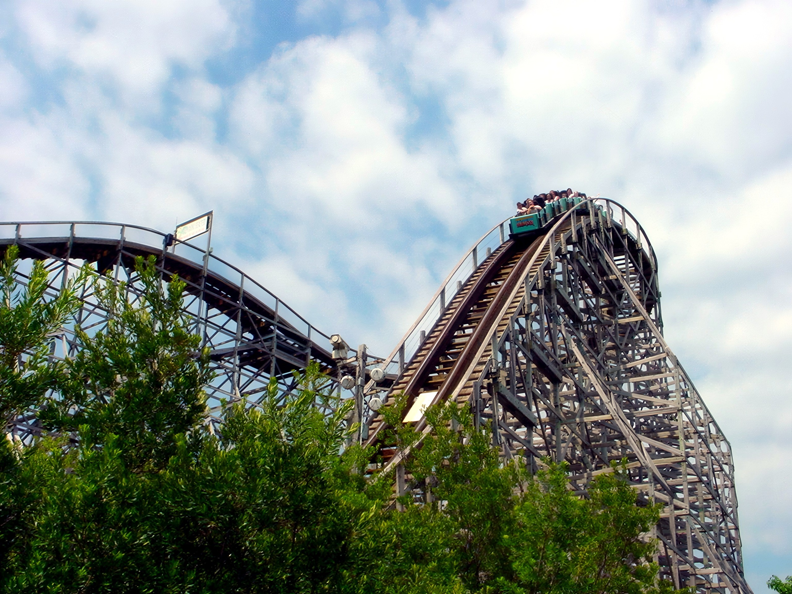 A Hurler train climbing the lift hill above the trees at Kings Dominion, July 2001