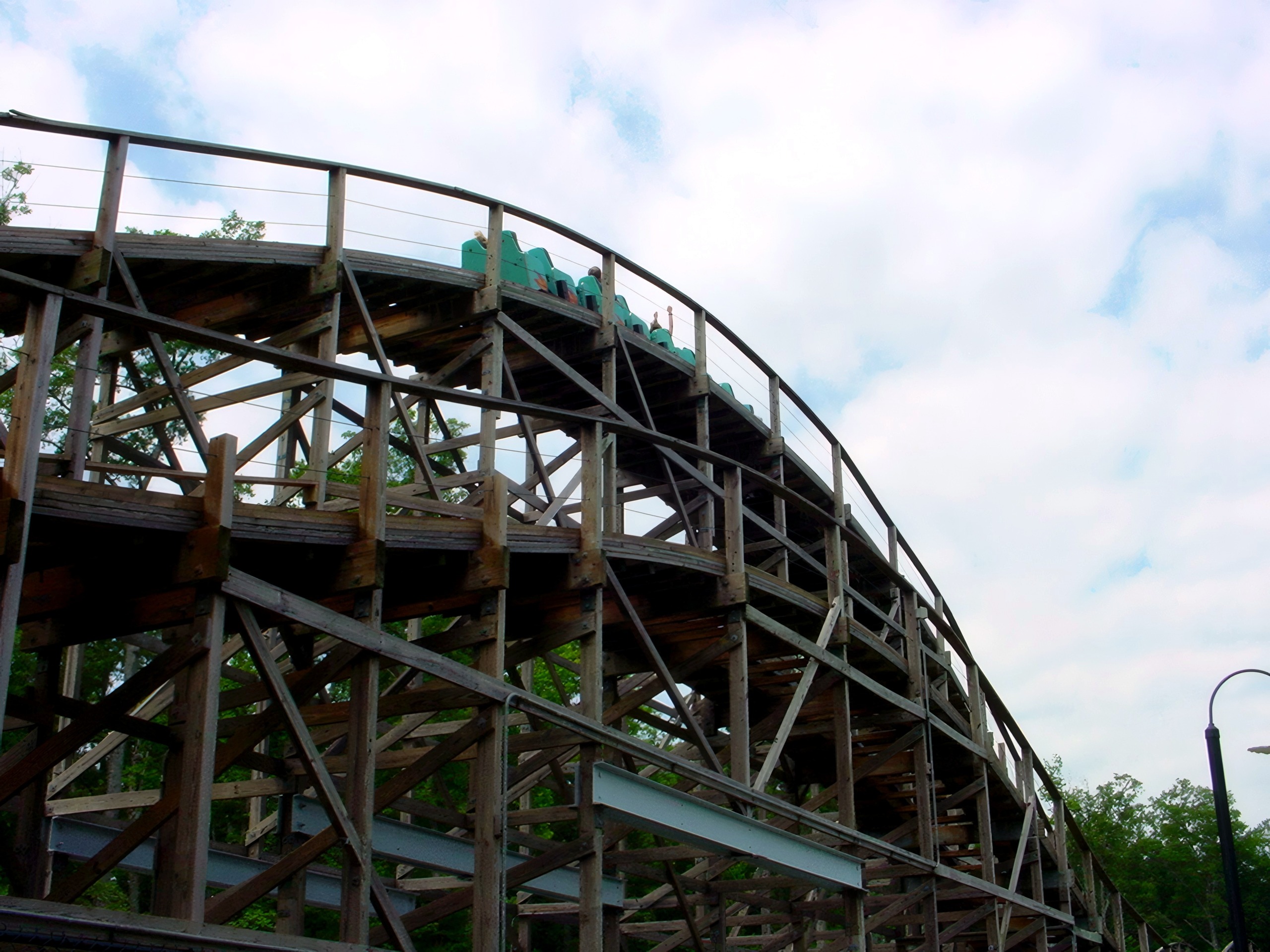 A Hurler train rounding a banked turn on the wooden structure at Kings Dominion, July 2001