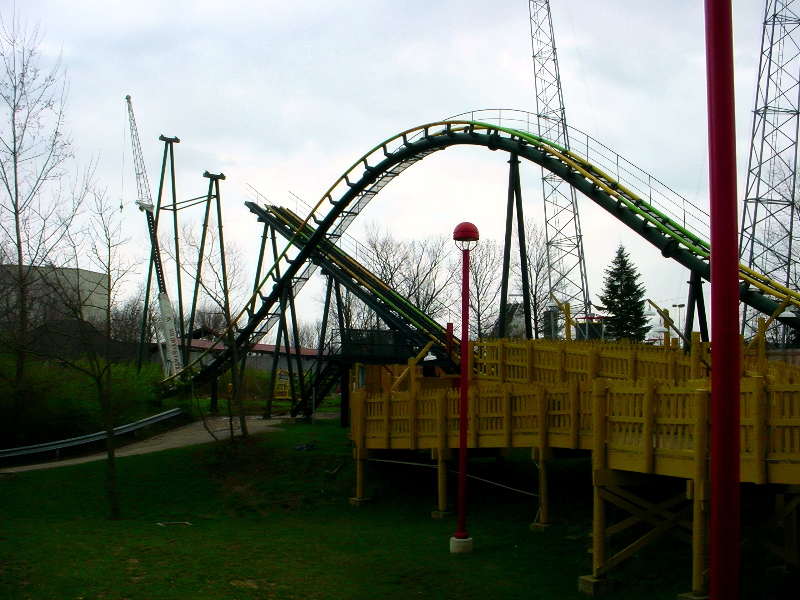 King Cobra's track arching over the yellow queue walkway at Paramount's Kings Island