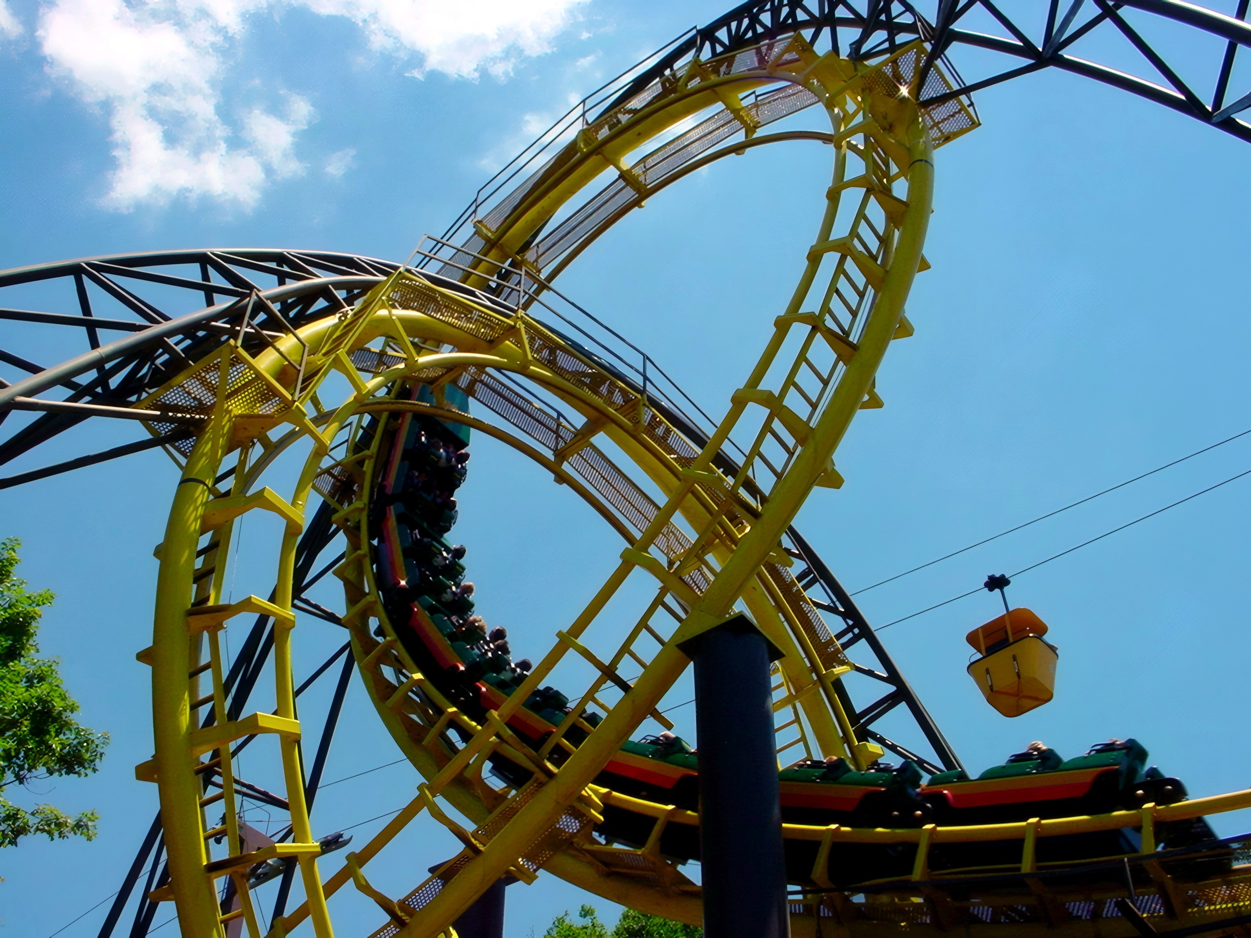 Loch Ness Monster trains in both interlocking loops with a skyride gondola passing at Busch Gardens Williamsburg, July 2001